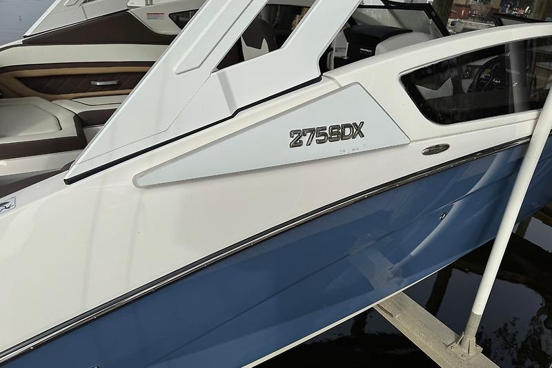 2023 Yamaha 275SDX boat, sleek design with blue and white exterior, docked.
