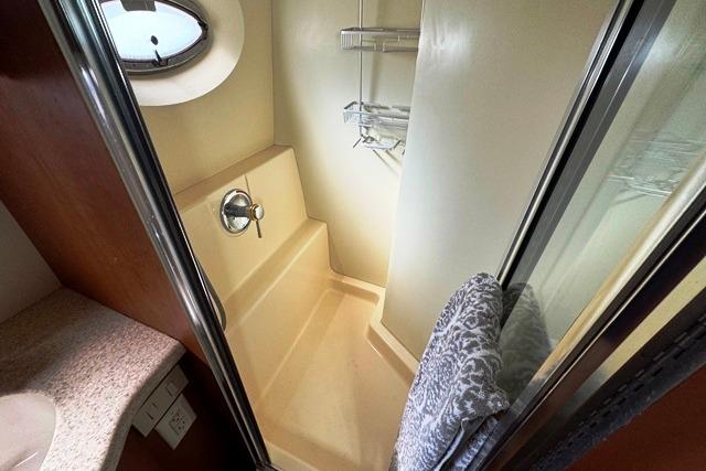 2004 Silverton 35 MY Aft Cabin Motoryacht shower with porthole and towel rack.