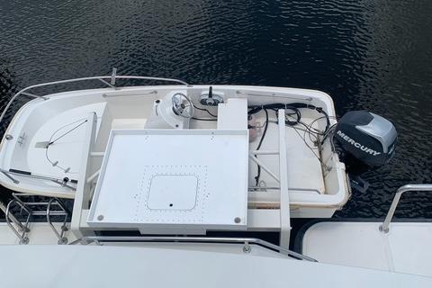 2005 Wendon 605 boat with Mercury outboard motor on calm water.