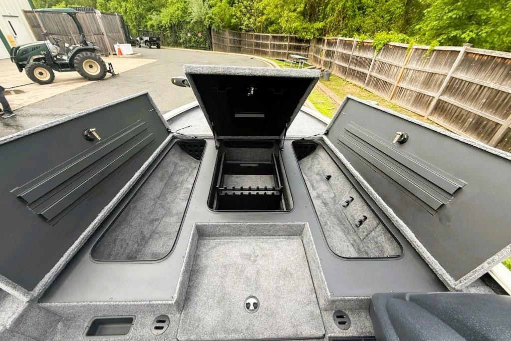 2025 Tracker Savage 215 boat storage compartments open, showcasing spacious interior design.