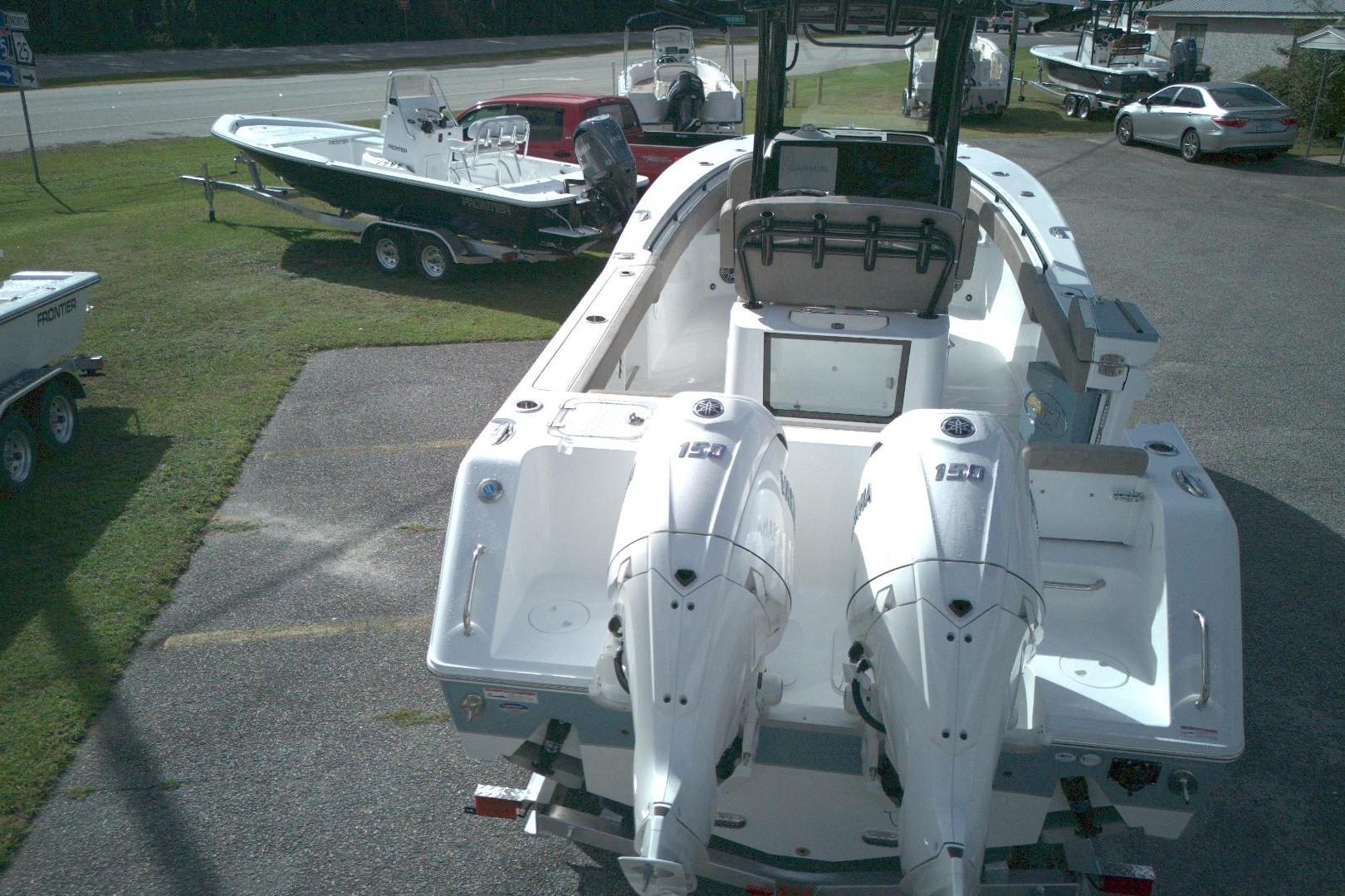 2026 Sea Hunt Gamefish 25 boat with dual 150 engines, parked on a lot.