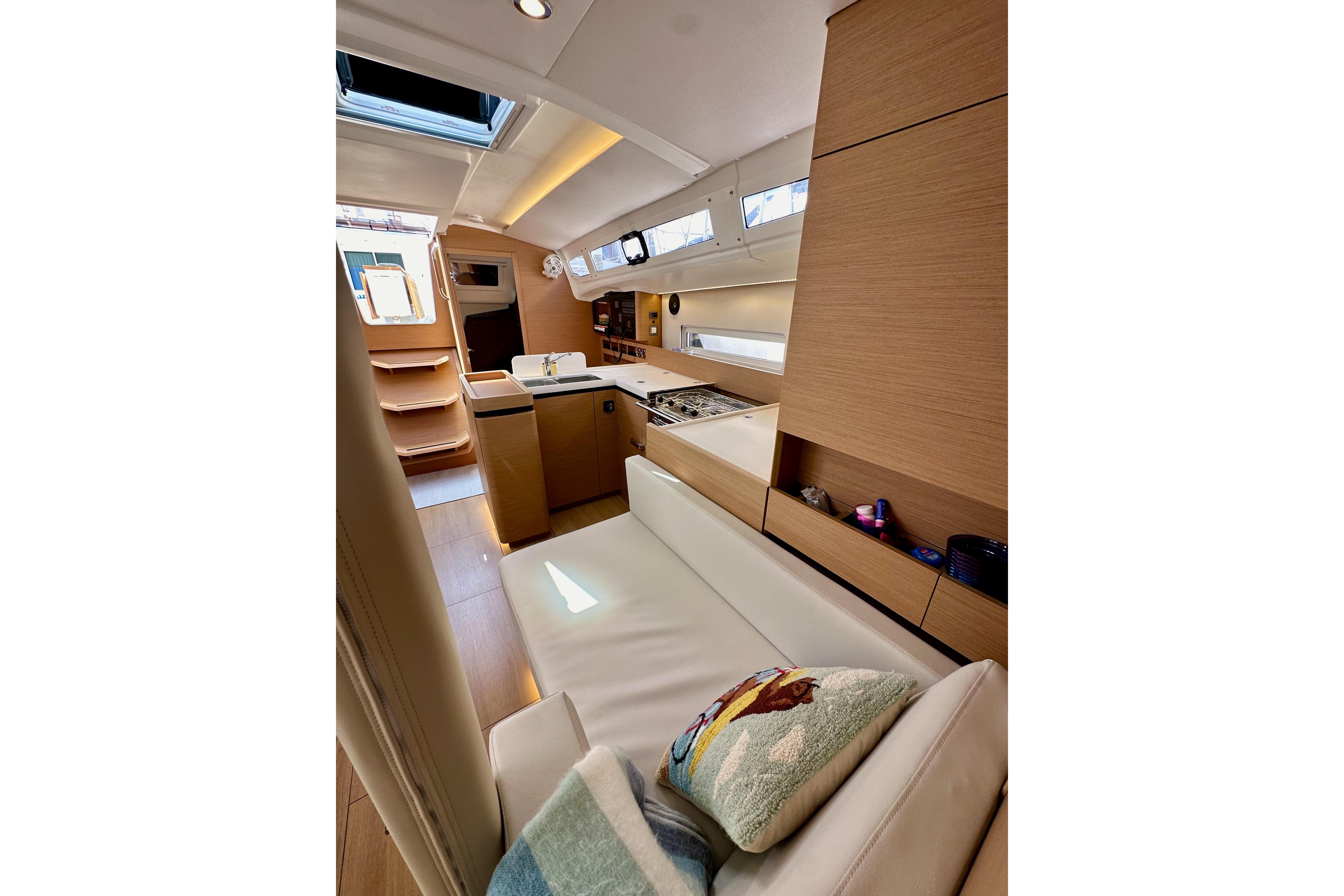 Interior of 2024 Jeanneau Sun Odyssey 410 yacht, featuring modern design and cozy seating.