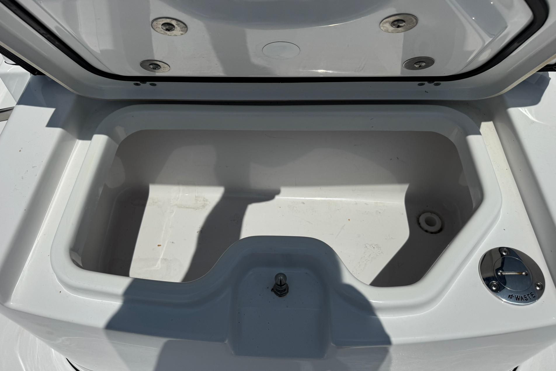 Open storage compartment on 2026 Sportsman Open 262 Center Console boat.