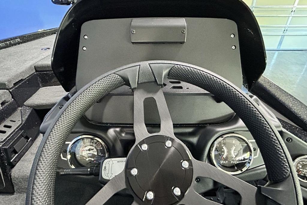 Steering wheel and dashboard of 2026 Skeeter ZX200 boat, featuring gauges and controls.