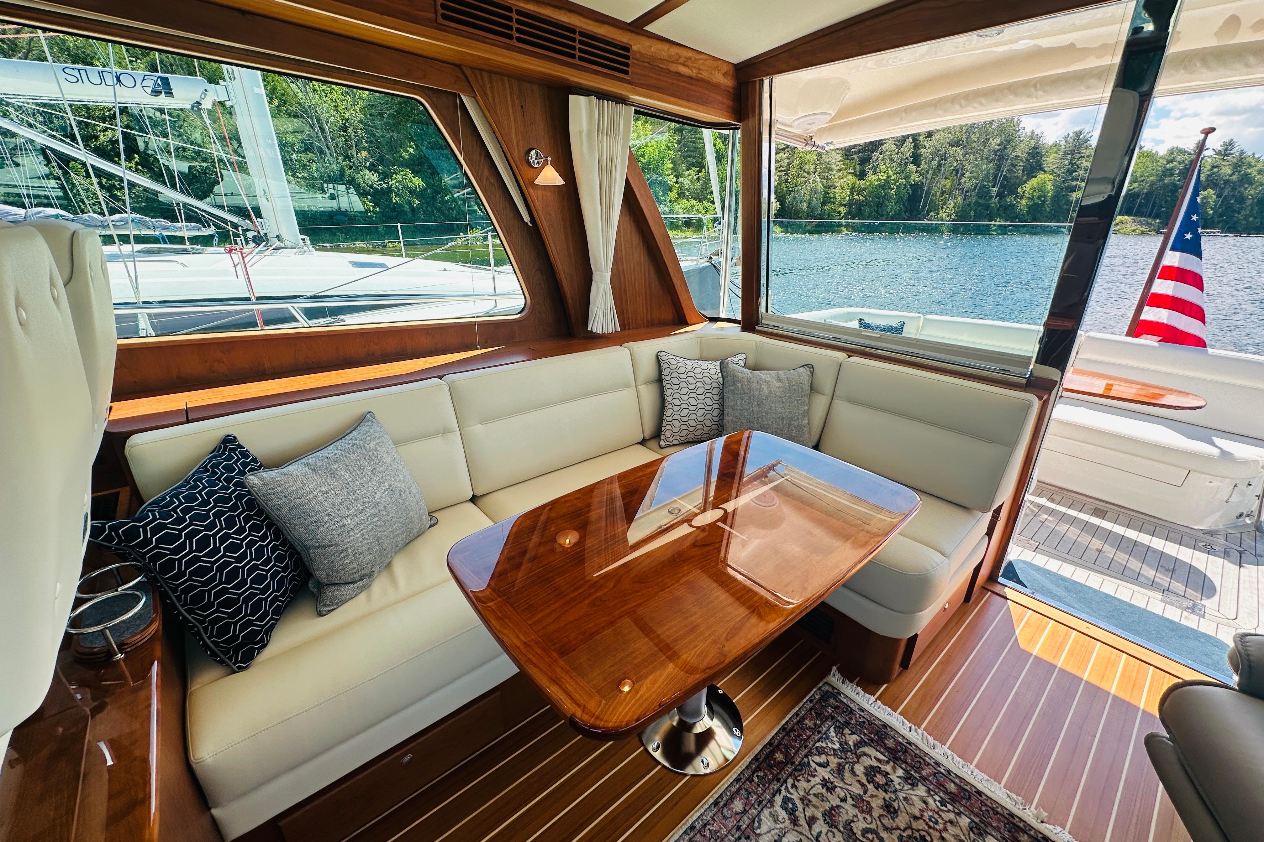 Interior of 2025 Sabre 48 Salon Express yacht with elegant seating and wooden table.