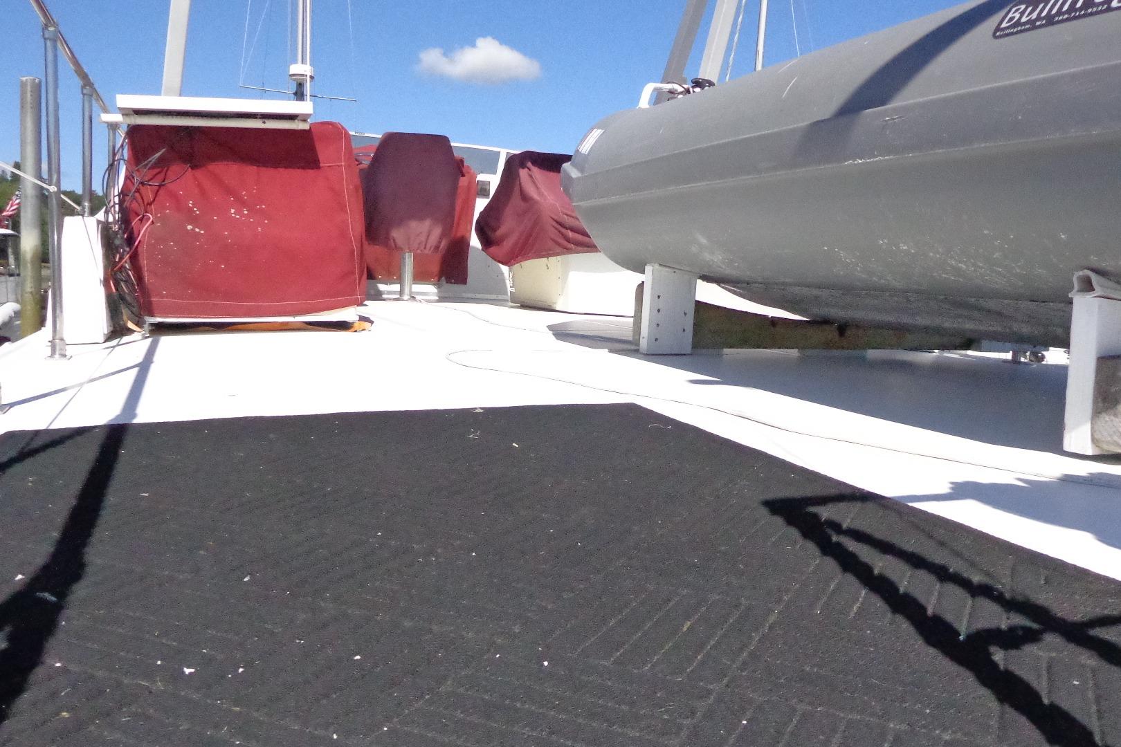 Deck view of a 1992 Cruise-A-Home Corsair 4200 with covered equipment and clear sky.