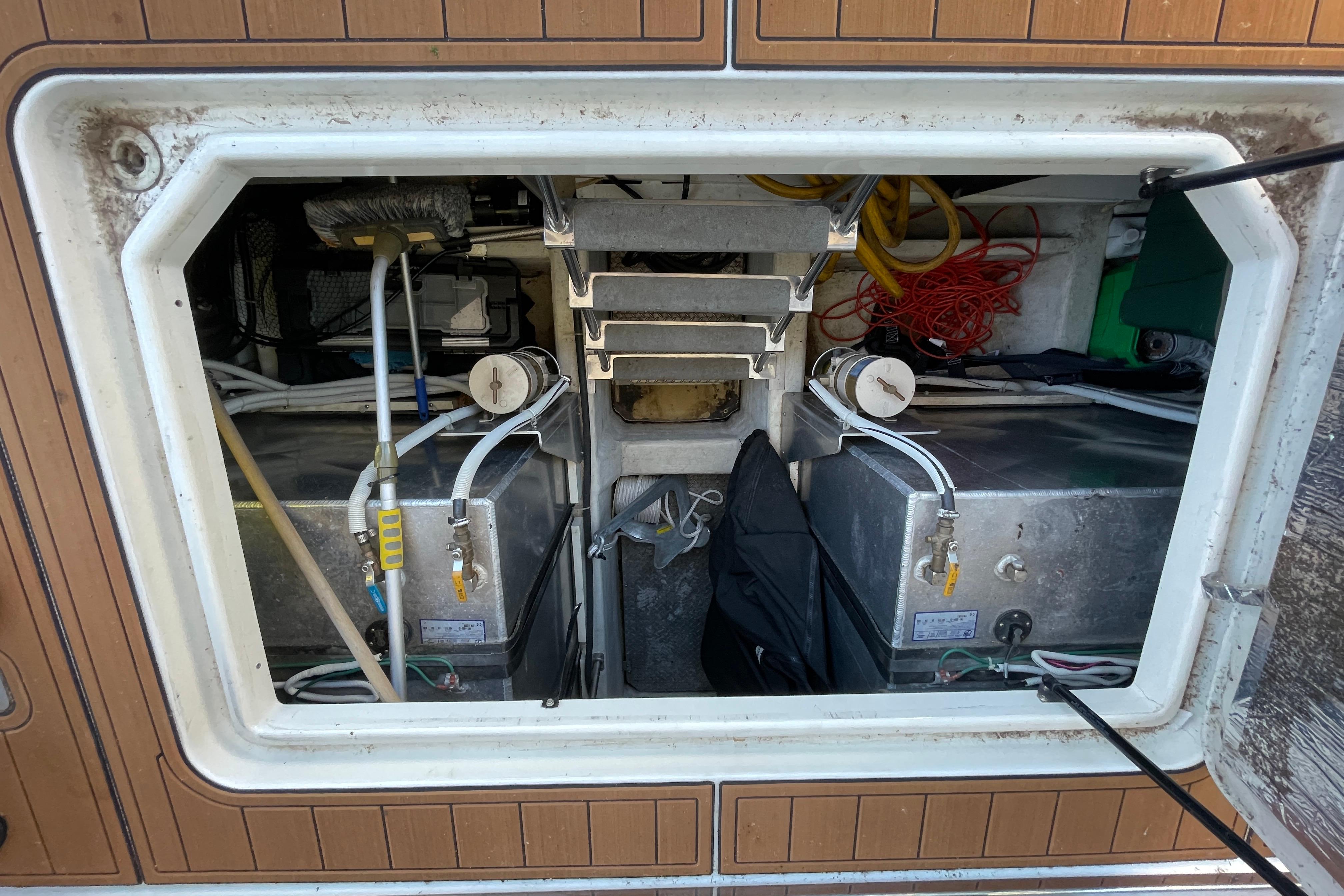 Storage compartment of a 2002 Carver 570 Voyager Pilothouse with equipment and wiring.