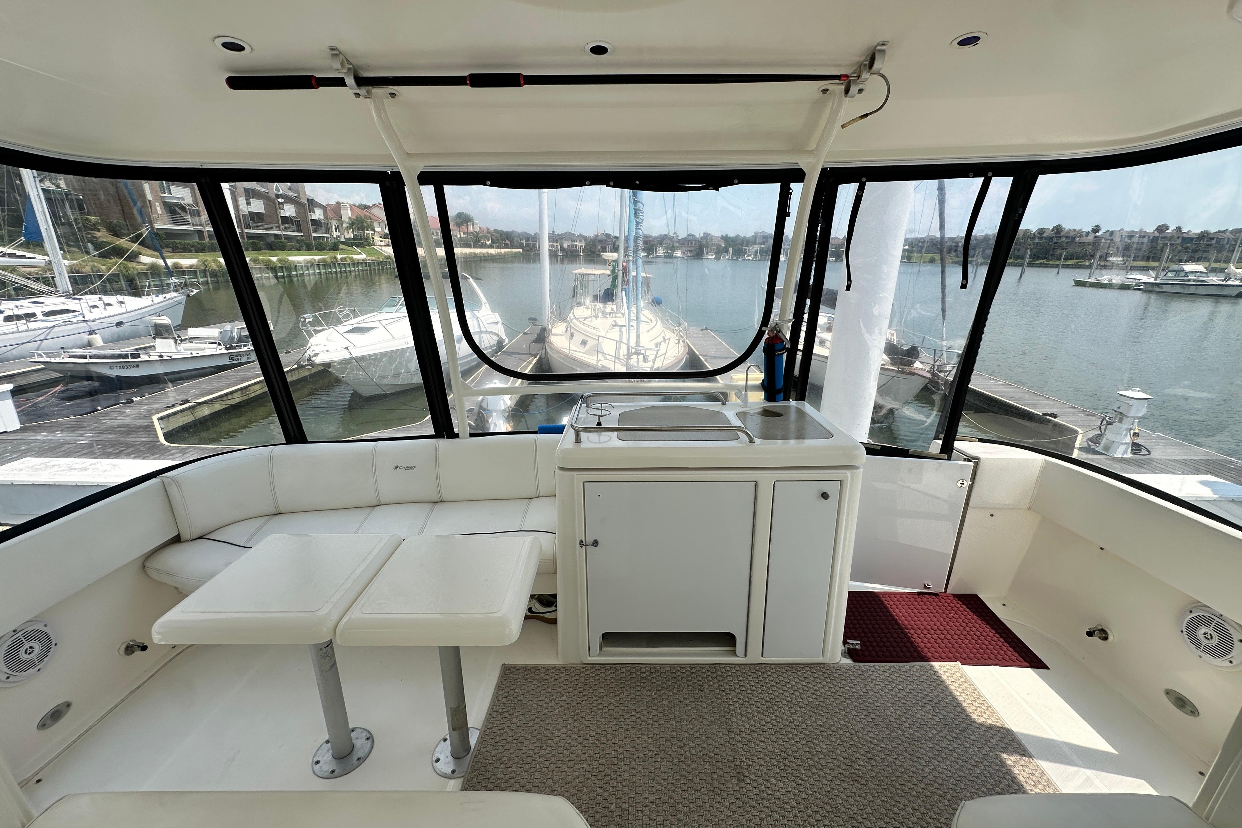 2004 Cruisers Yachts 405 Express Motoryacht interior with seating and marina view.