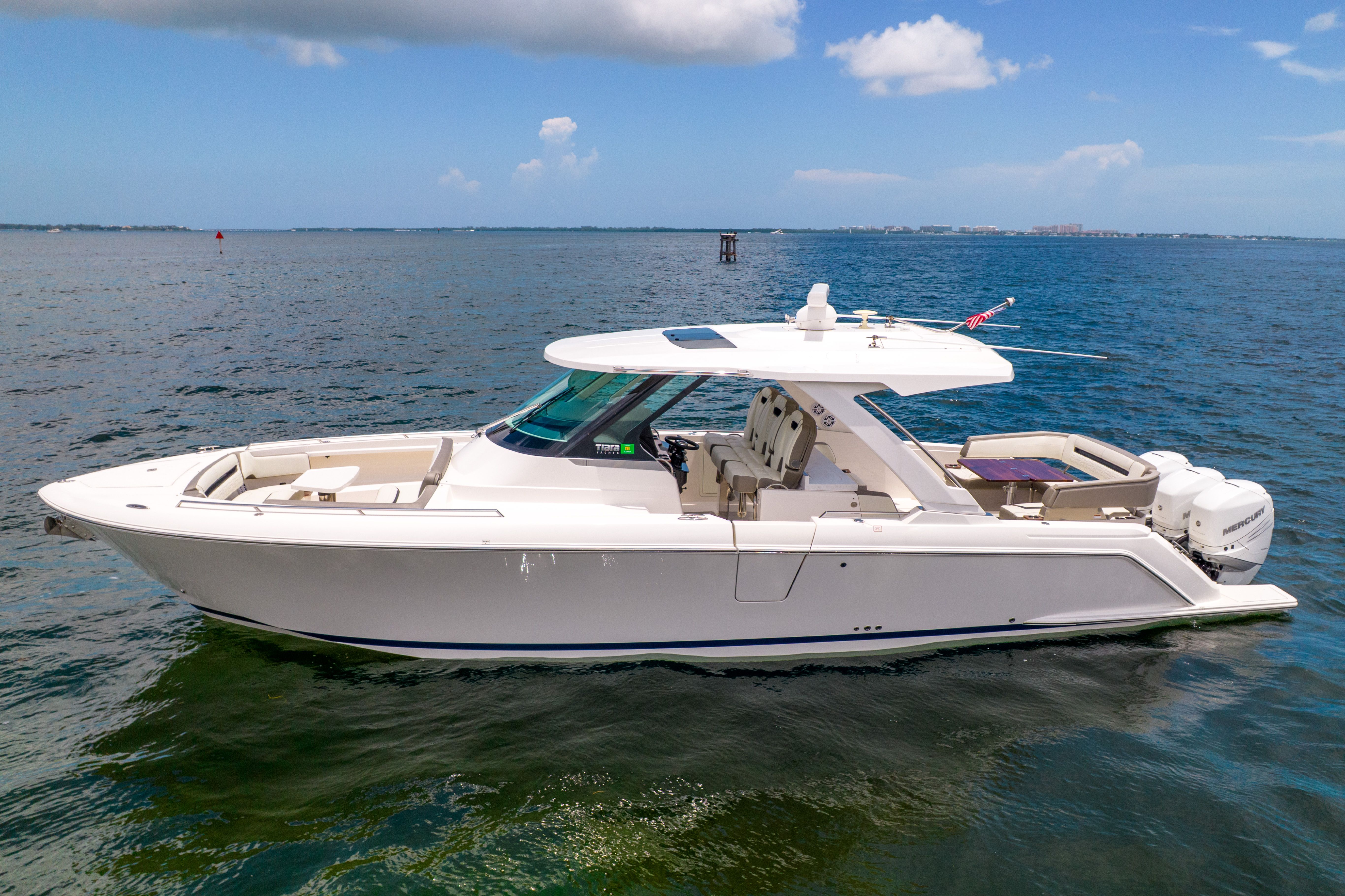 2023 Tiara Yachts 38 LS on calm water with a clear sky.