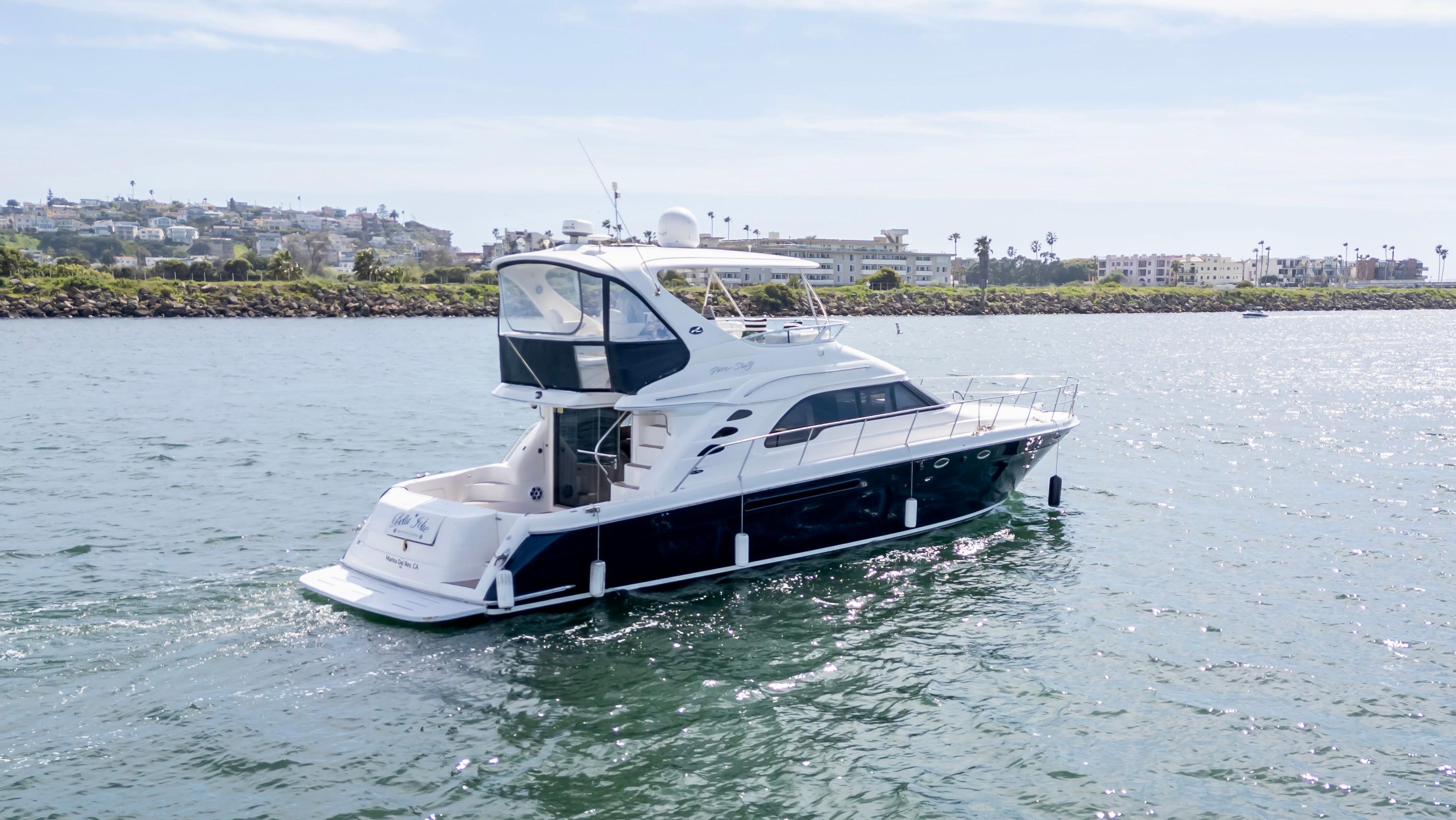 2002 Sea Ray 560 Sedan Bridge yacht cruising on a sunny day.