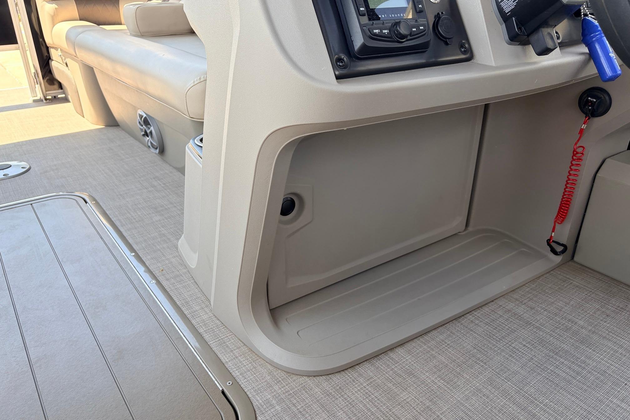 2024 Sun Tracker SportFish 22 XP3 interior with beige seating and control panel.