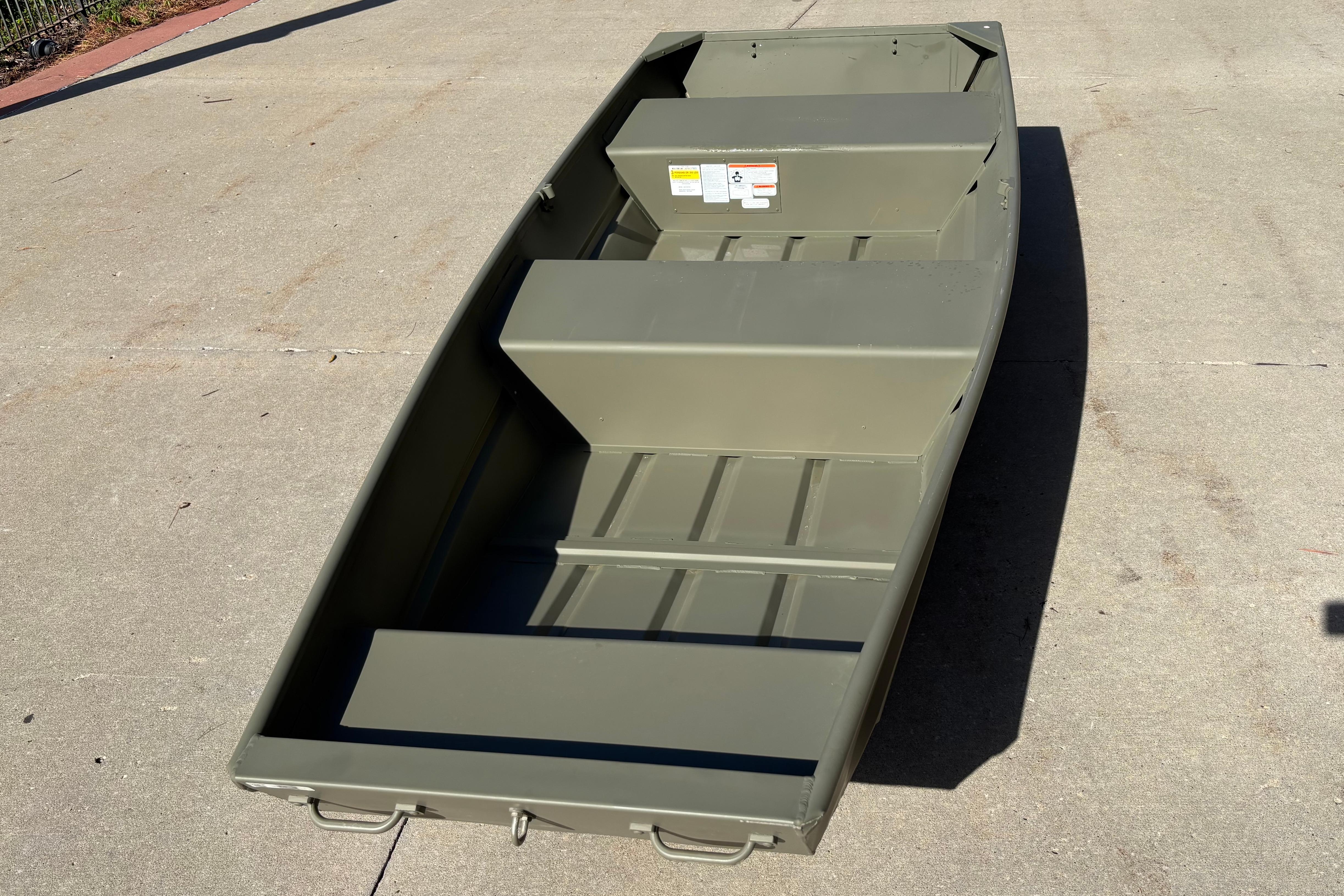 2026 Tracker Grizzly 12 Jon boat on concrete surface, showcasing its sturdy design.