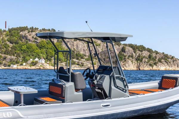 Manufacturer Provided Image: 2025 Highfield Sport 760 boat on scenic water with rocky shoreline backdrop.