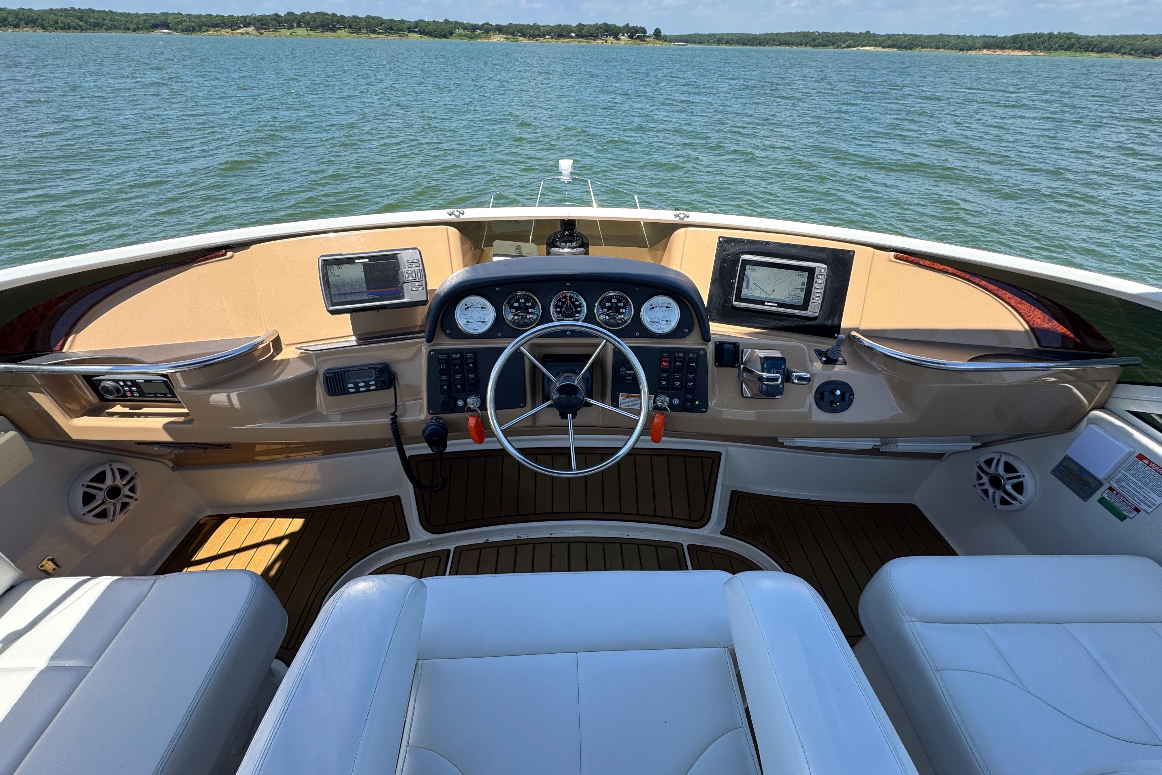 Helm of 2002 Carver 396 Motor Yacht with navigation instruments and leather seating.