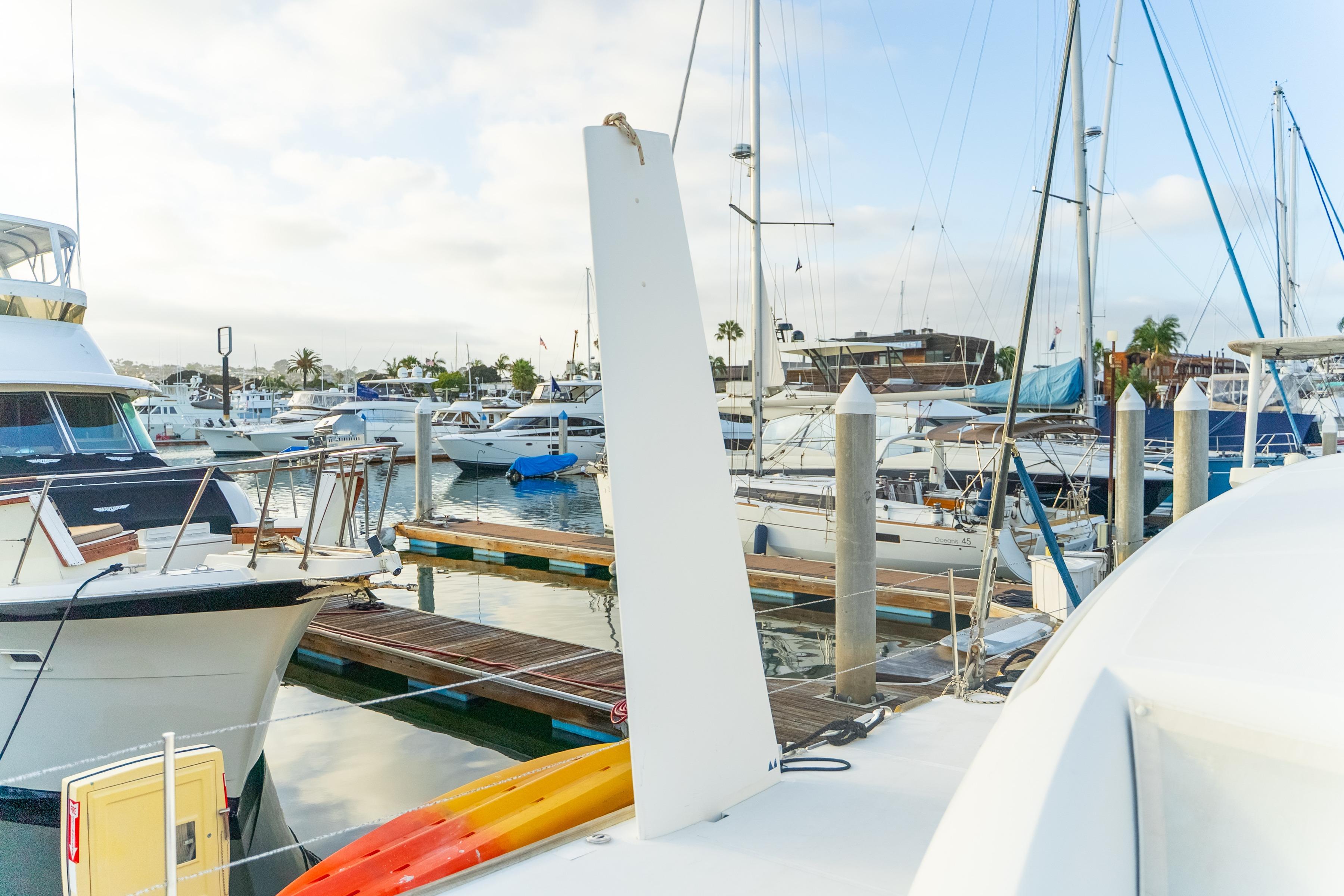 Marina with Catana 65 yacht, 2009 model, surrounded by various boats and docks.