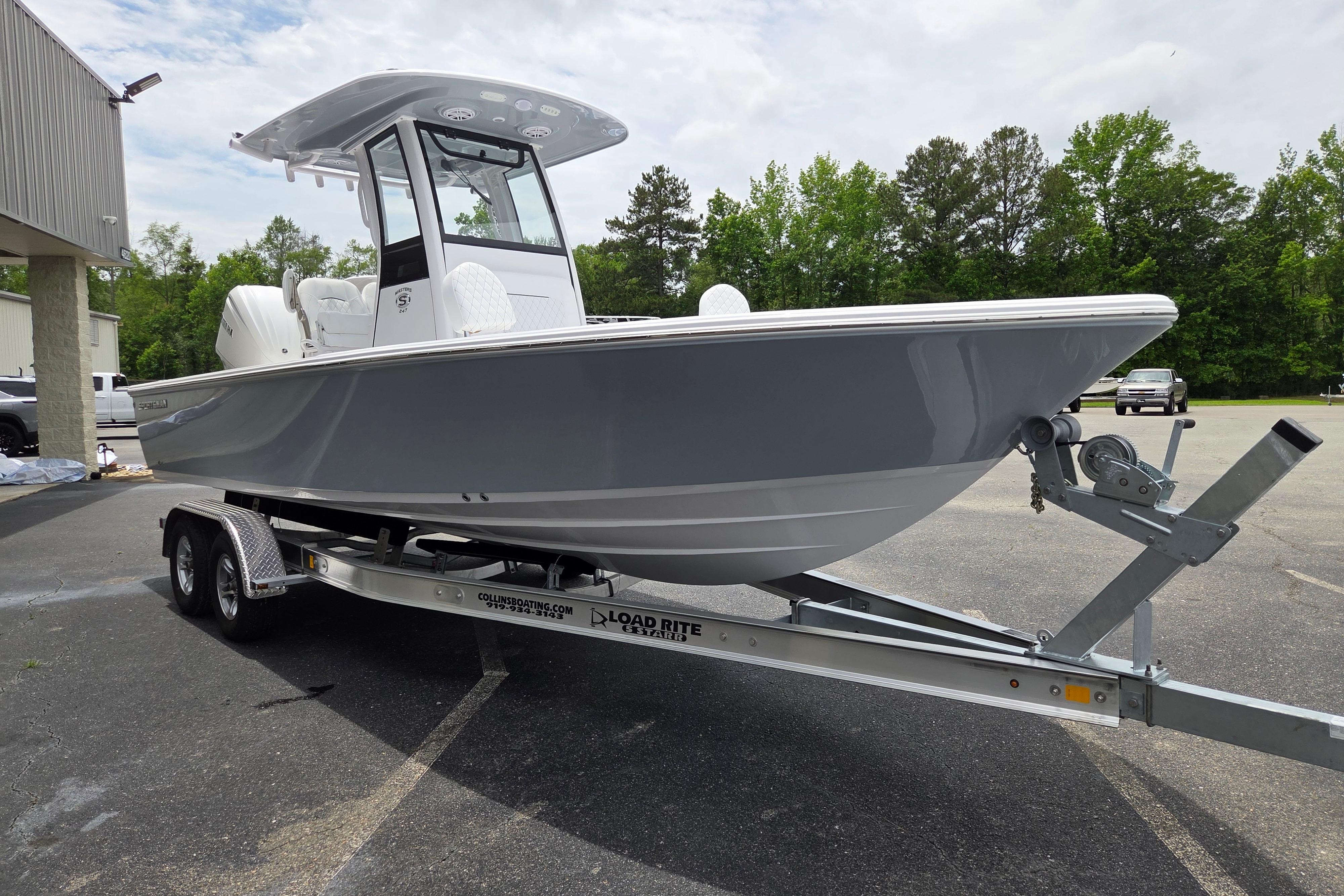 2026 Sportsman Masters 247 Bay Boat on trailer, parked outdoors.