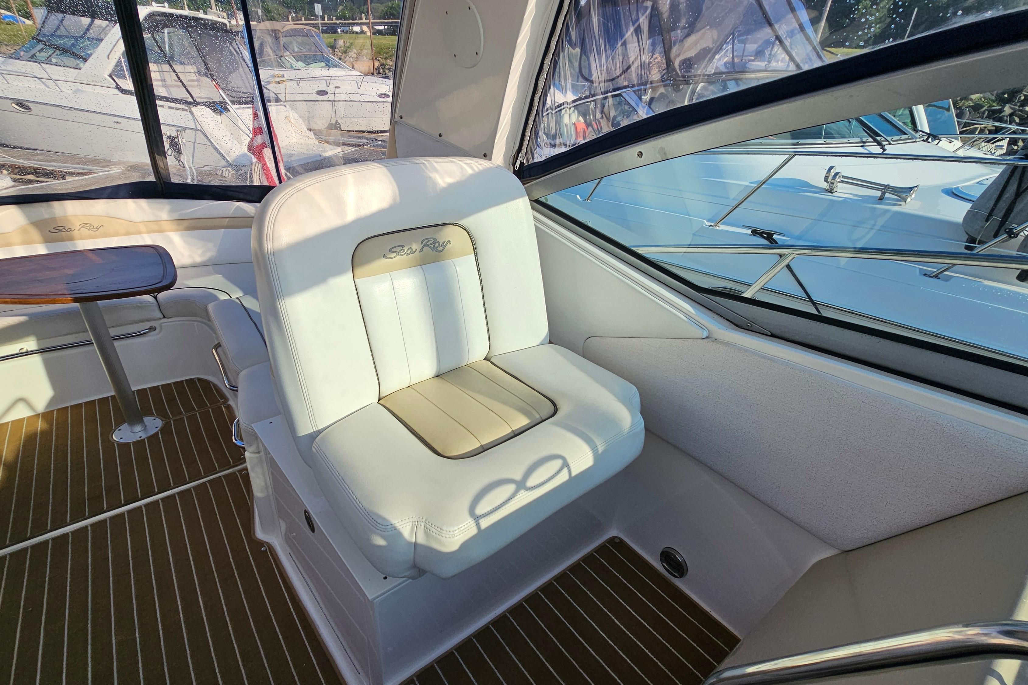 Interior of 2008 Sea Ray Sundancer 350 yacht with plush seating and wooden table.