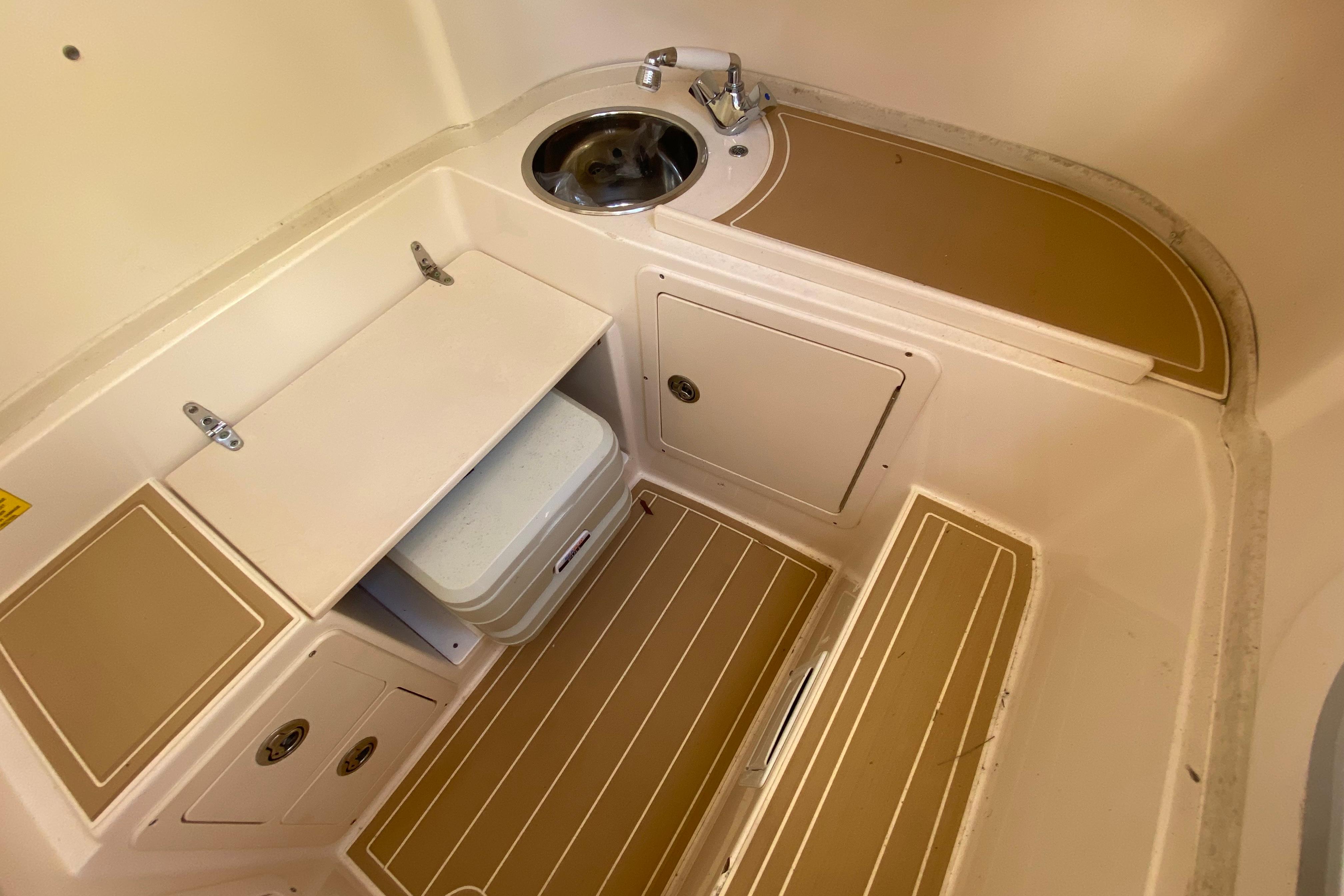 2004 Grady-White Canyon 283 boat interior with sink and storage compartments.