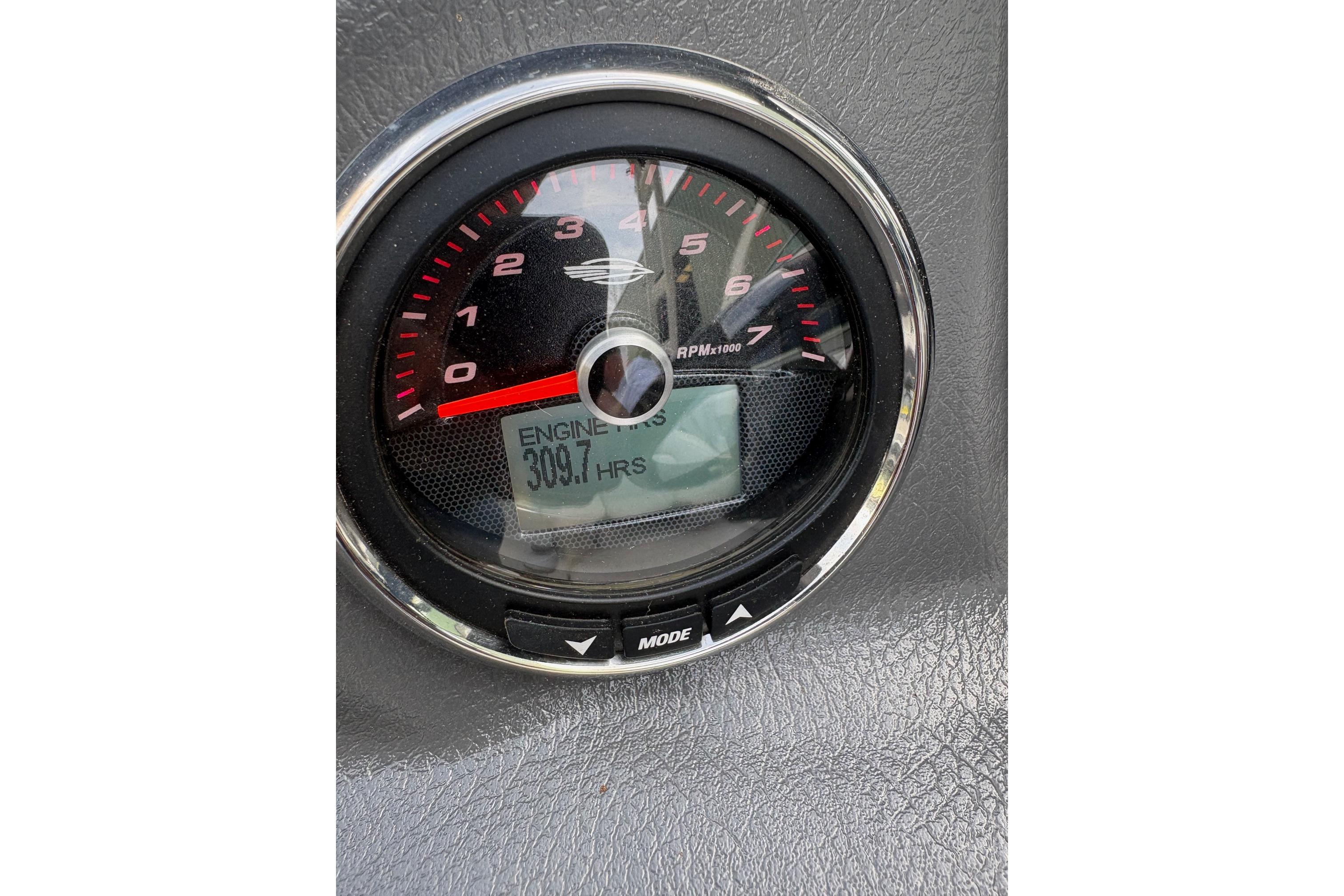 Tachometer of 2016 Chaparral 246 SSi showing 309.7 engine hours.