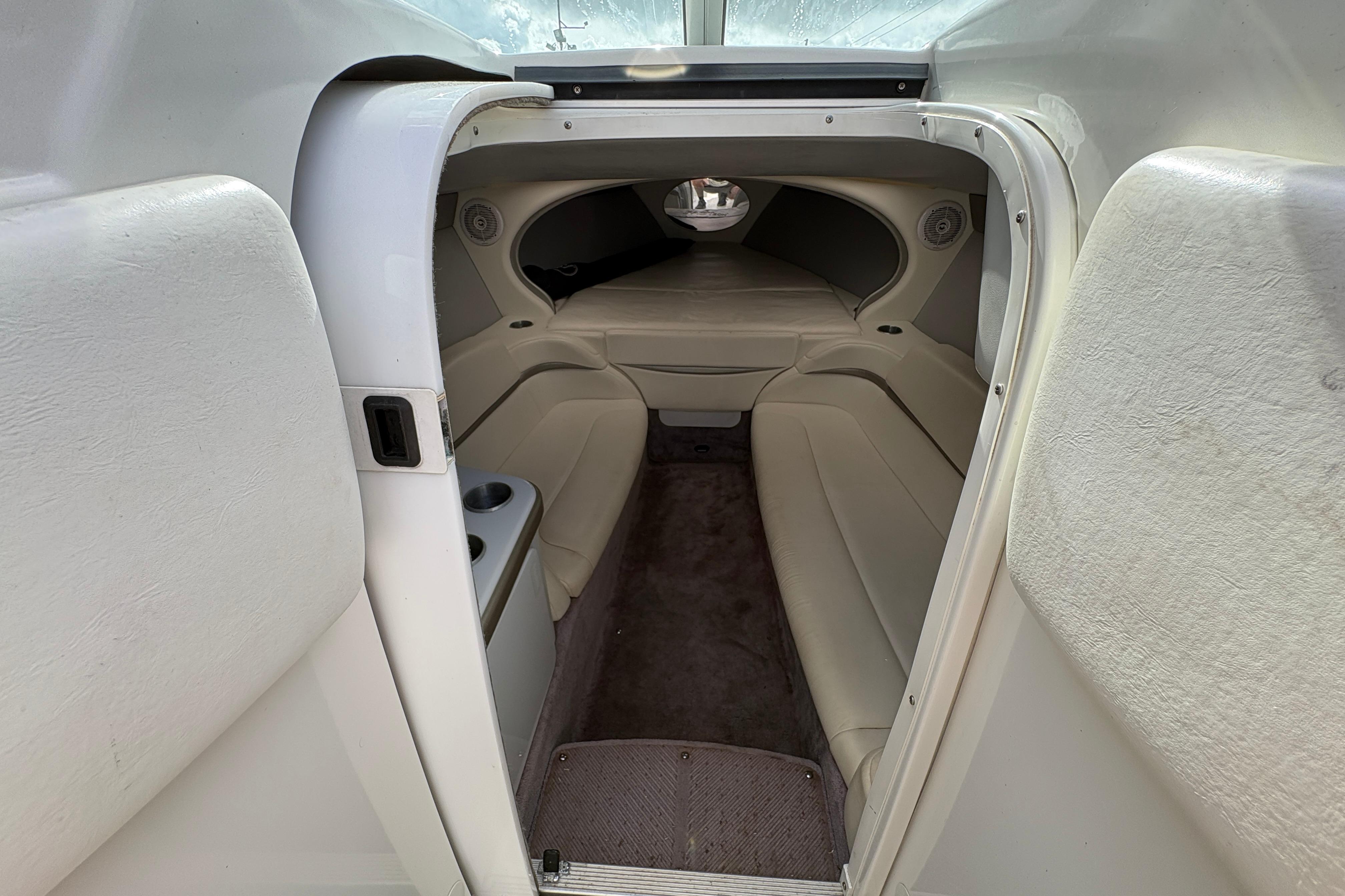 Interior cabin of a 2002 Formula 292 FASTech boat, featuring beige seating and compact design.