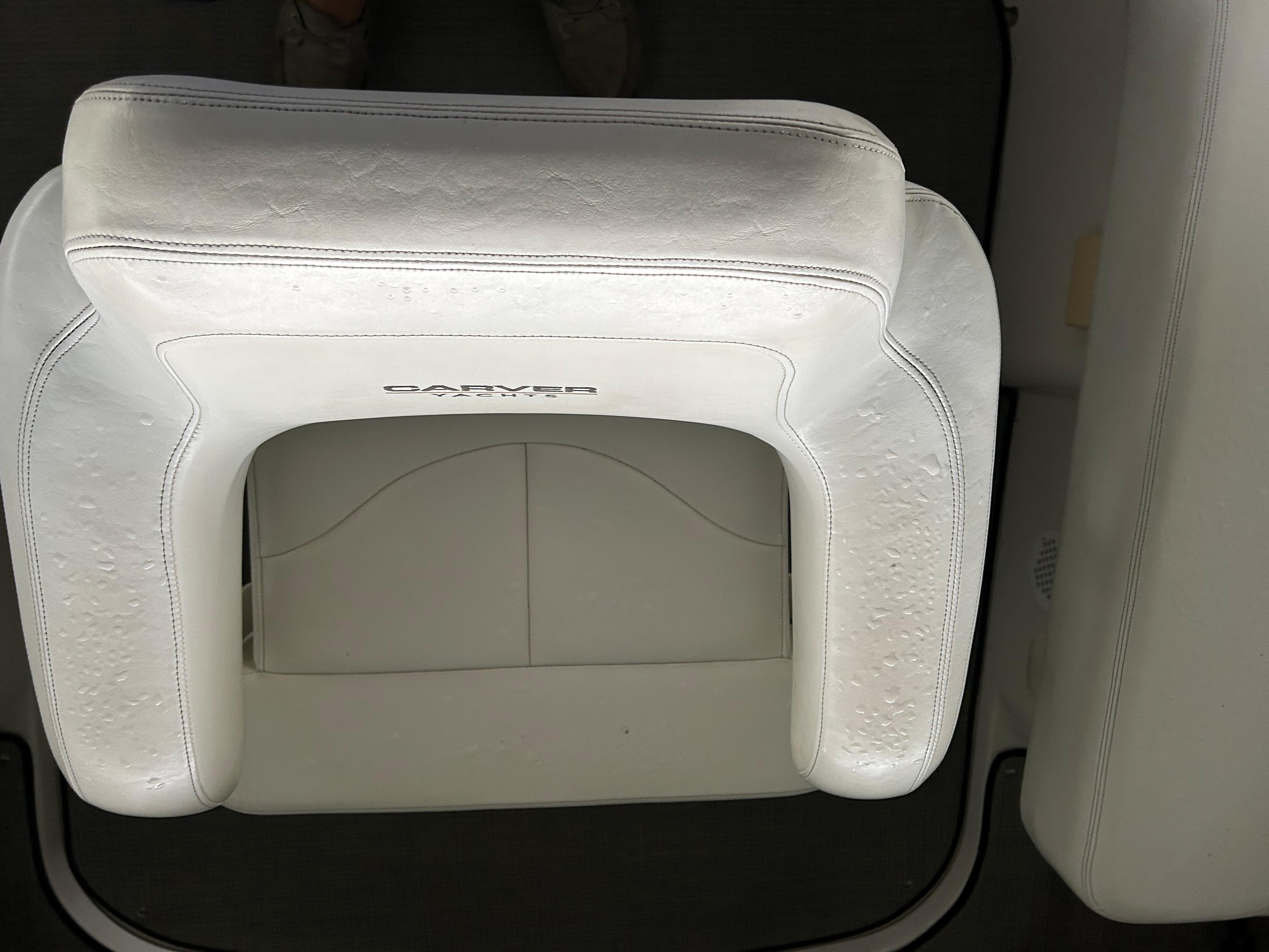 White leather seat on a 2000 Carver 396 boat, featuring elegant stitching.