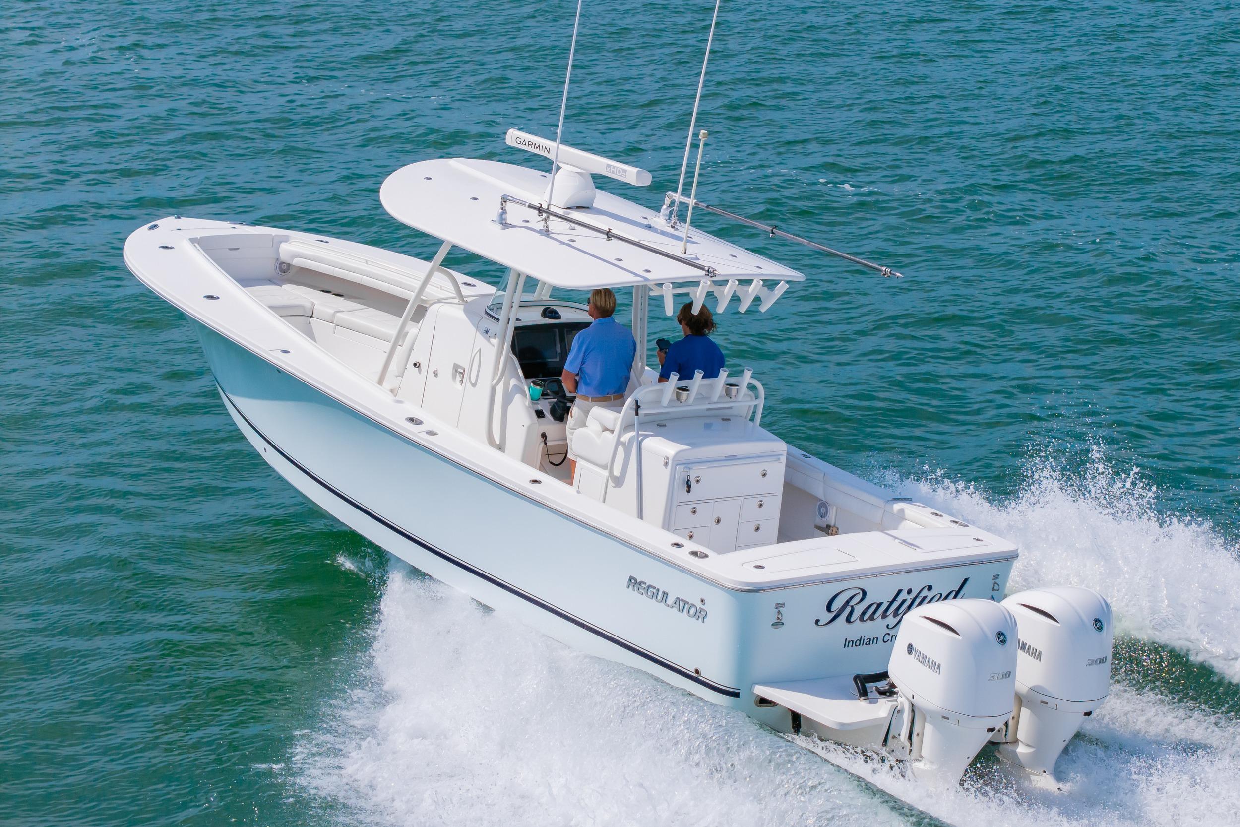 2019 Regulator 31 boat cruising on open water with twin Yamaha engines.