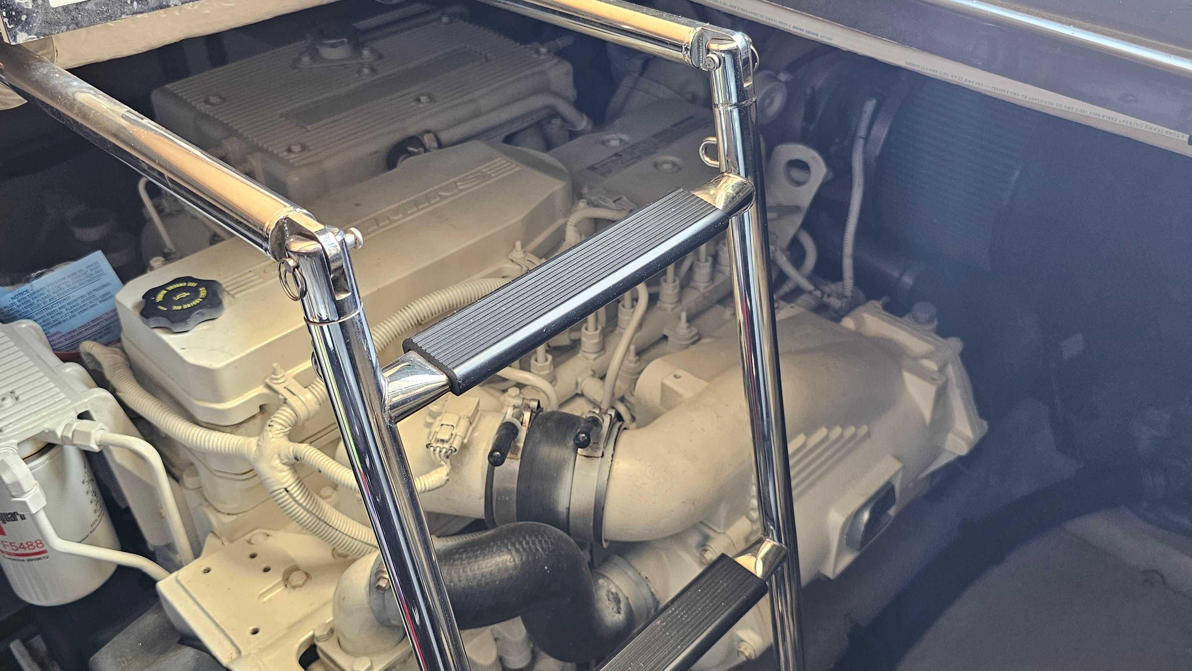 Engine compartment of a 2016 Sea Ray 470 Sundancer with visible ladder and components.