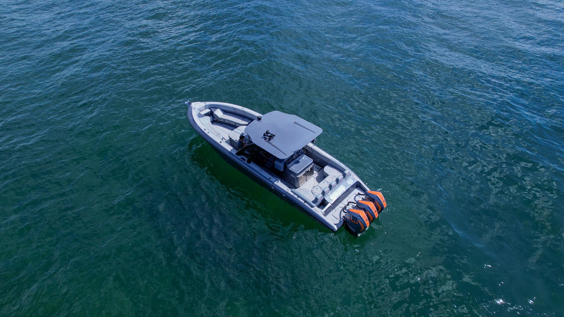 2022 Midnight Express 37' Open boat on calm water, aerial view.