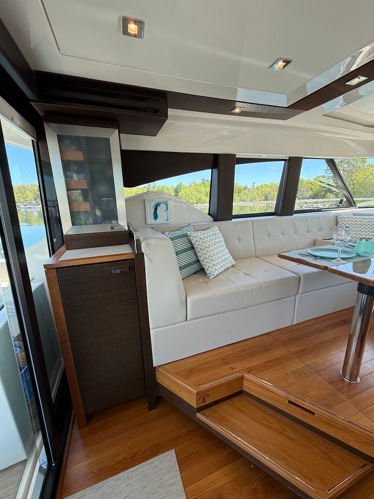 Interior of a 2017 Tiara Yachts C44 Coupe with elegant white upholstery.