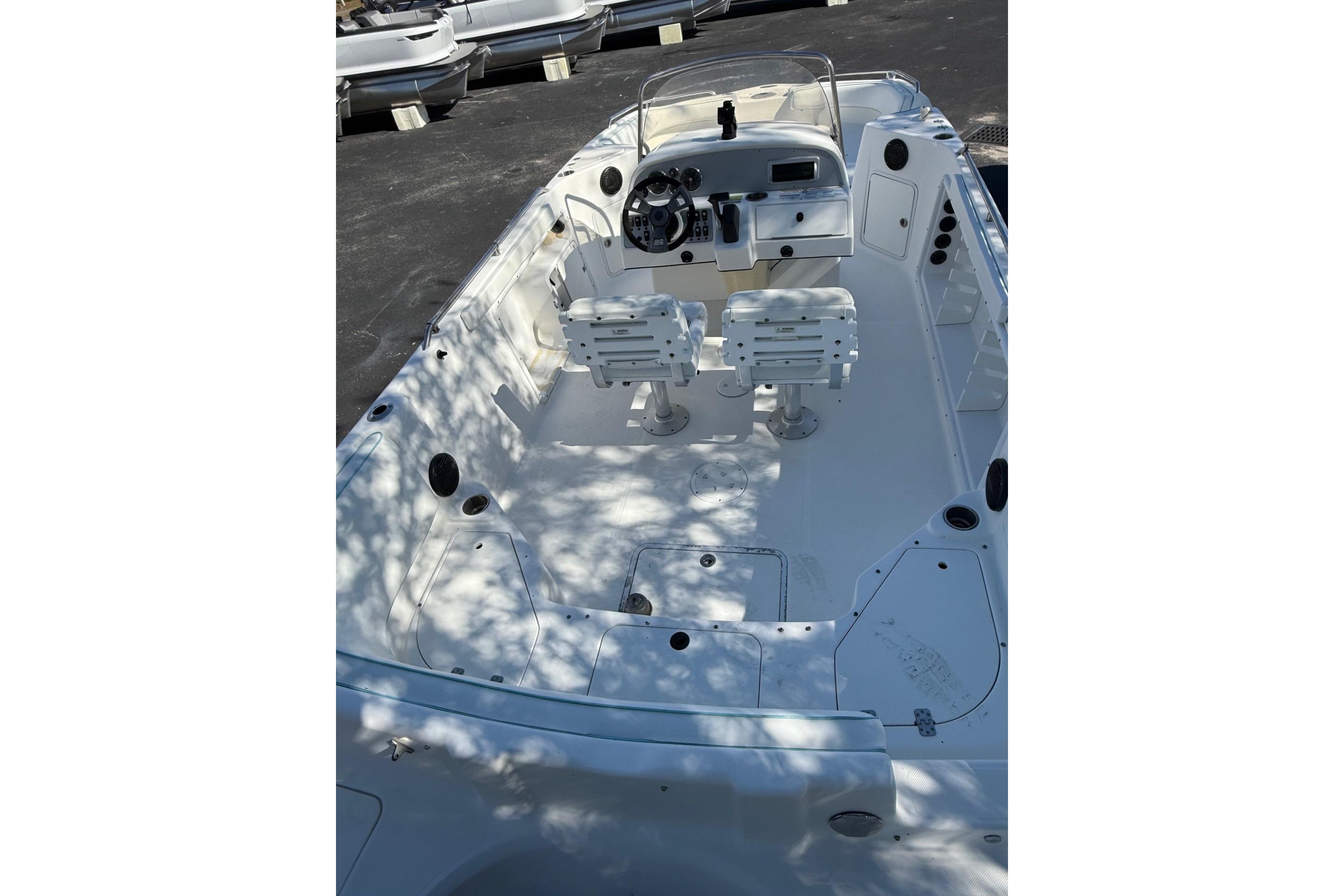 2015 Hurricane SunDeck Sport CC 231 OB boat interior with dual seats and steering console.