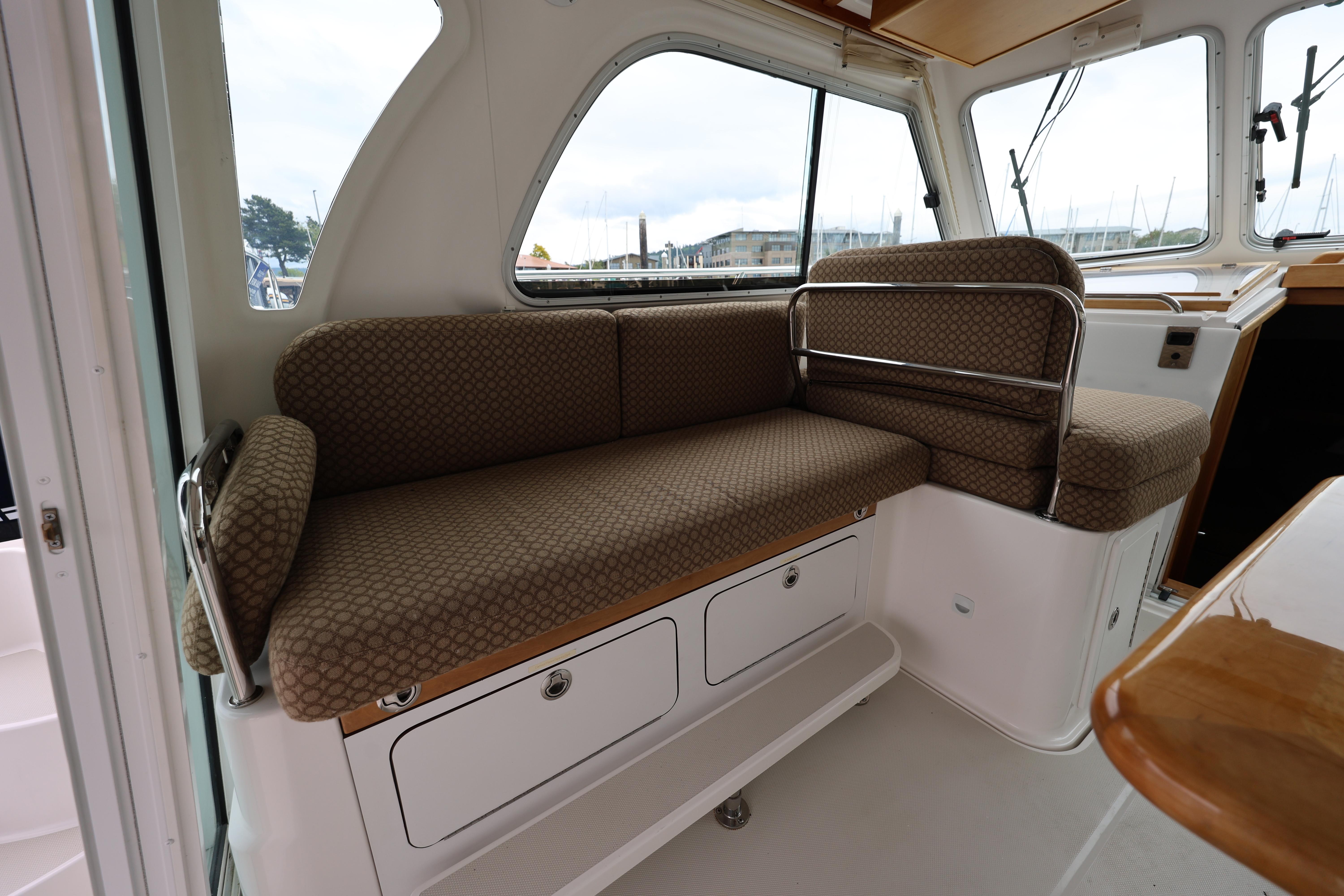 2011 Back Cove 30 interior seating area with patterned cushions and storage compartments.