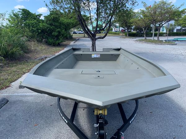 2025 Tracker GRIZZLY 2072 Utility boat on trailer in parking lot.