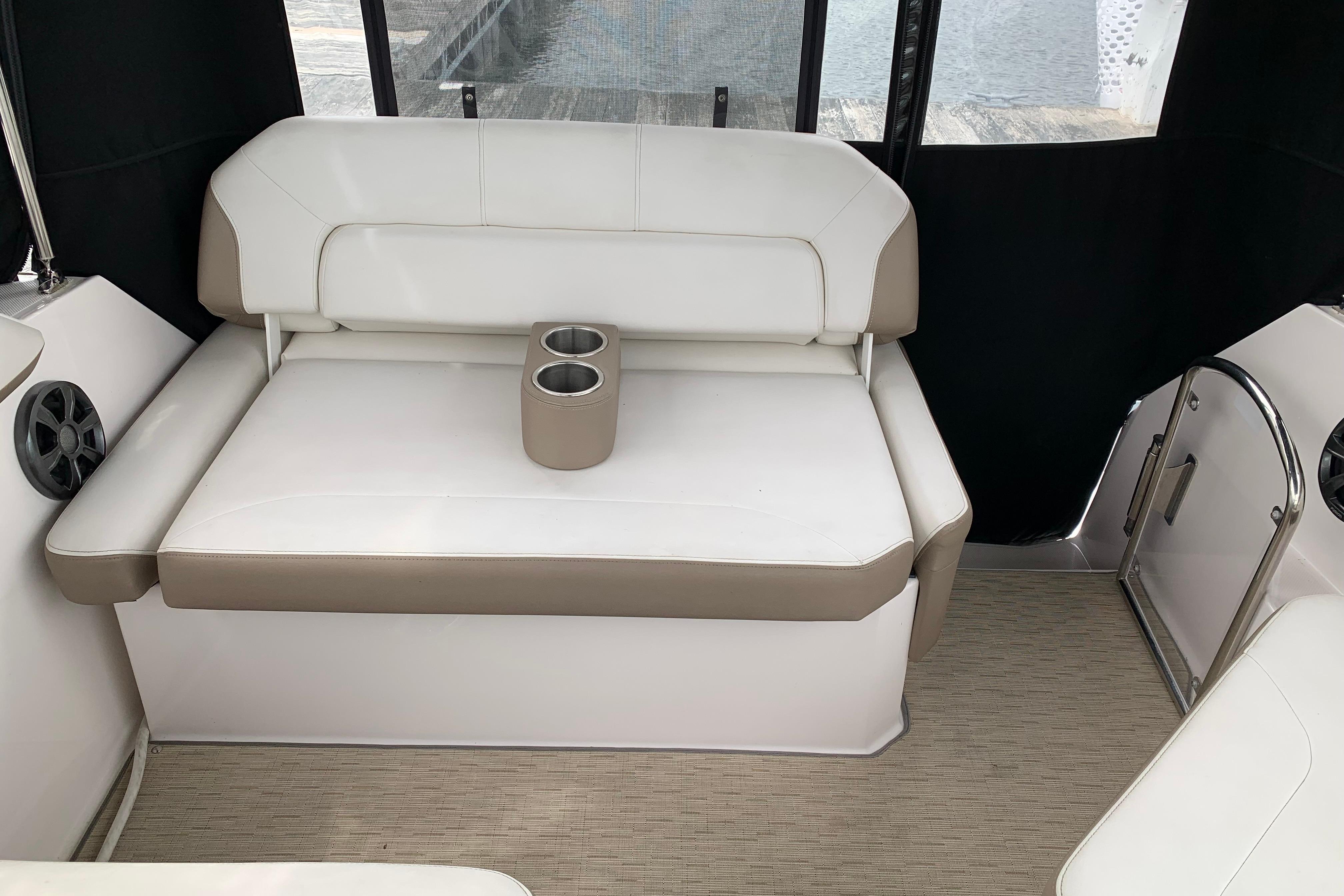 Interior seating of 2017 Regal 26 Express boat with cup holders.