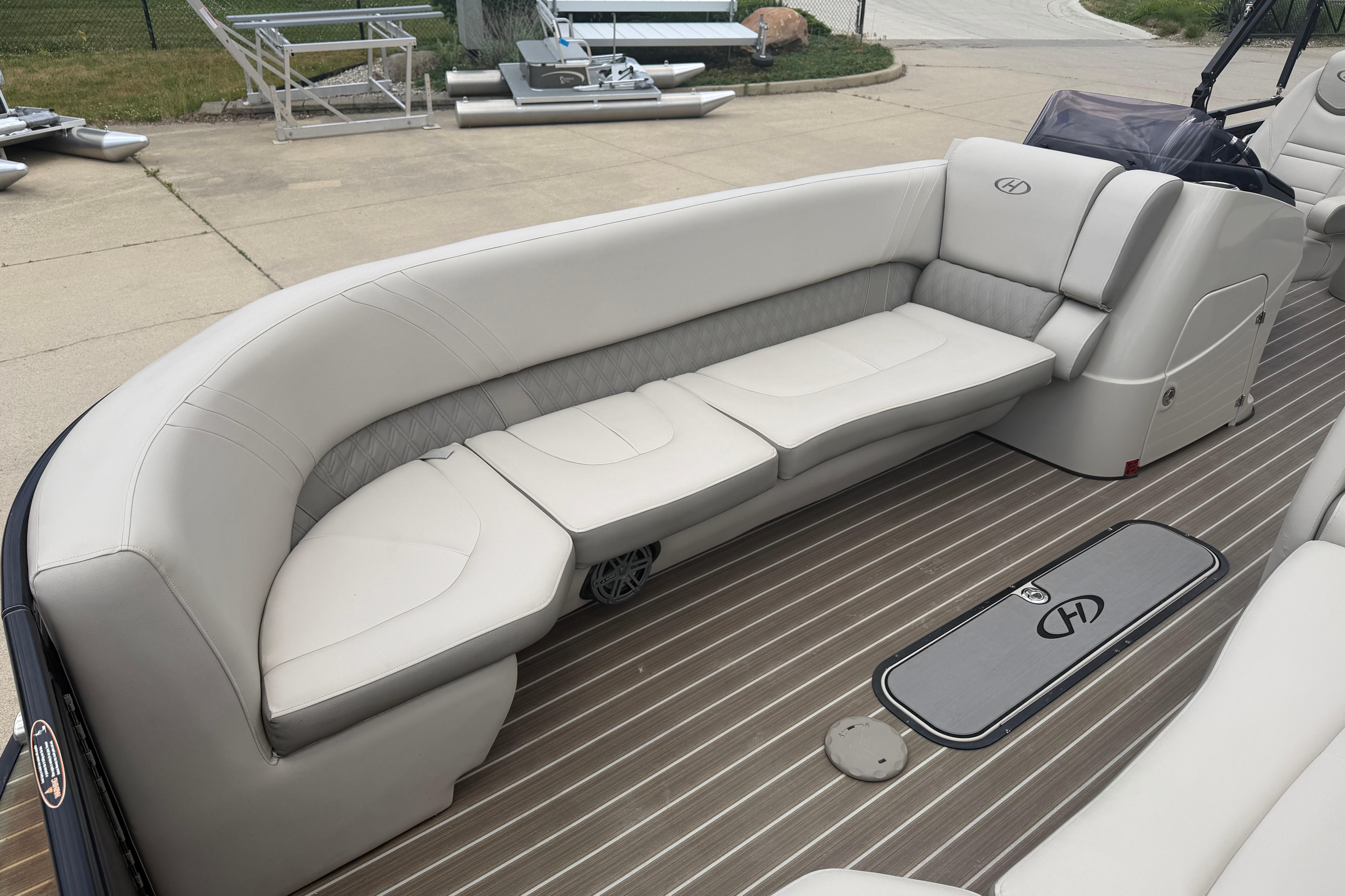 2019 Harris Solstice 240 boat interior with elegant seating and wood-style flooring.