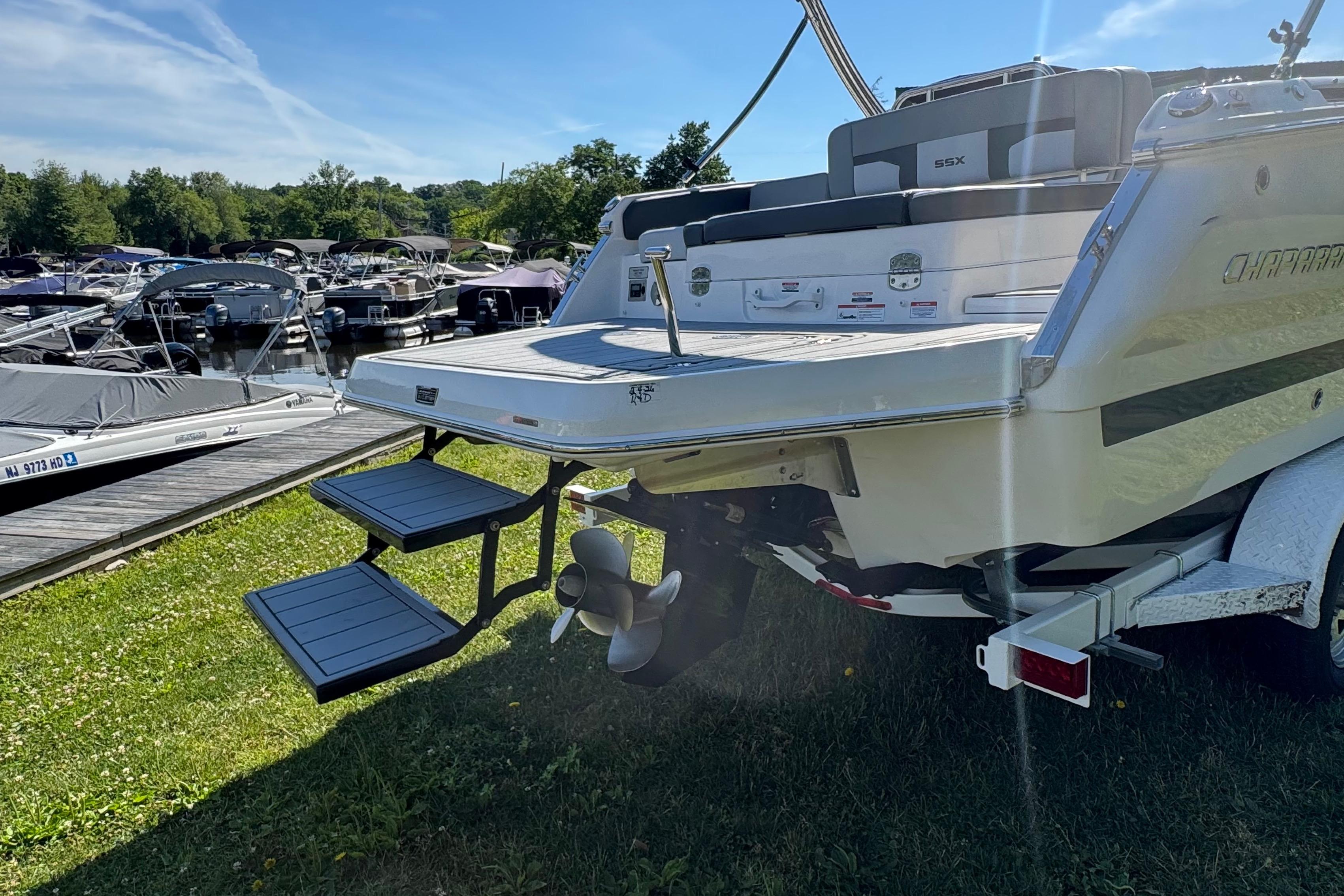 2026 Chaparral SSX 4 boat at marina, featuring swim platform and ladder.