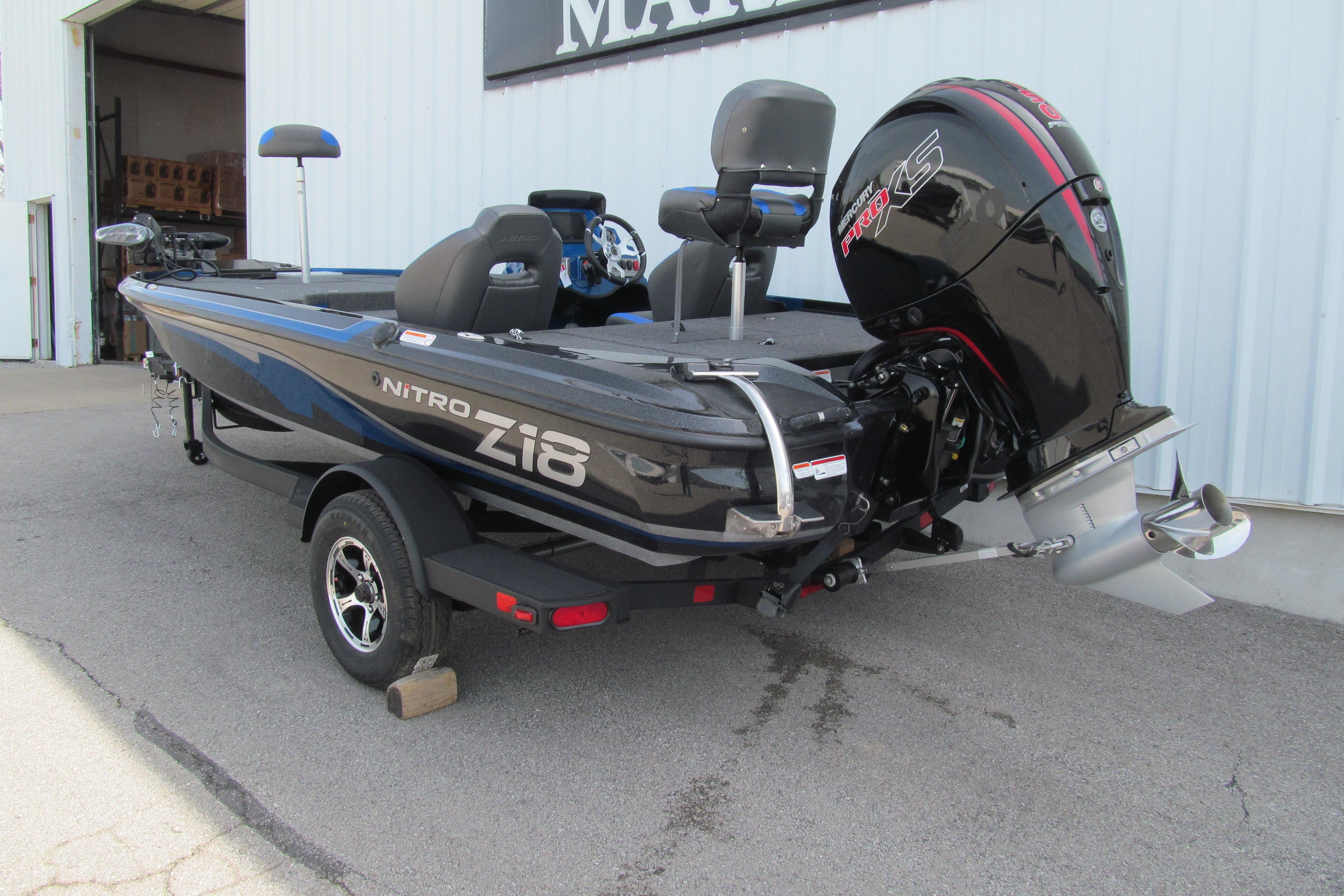 2026 Nitro Z18 Pro boat with powerful outboard motor, parked outside a building.