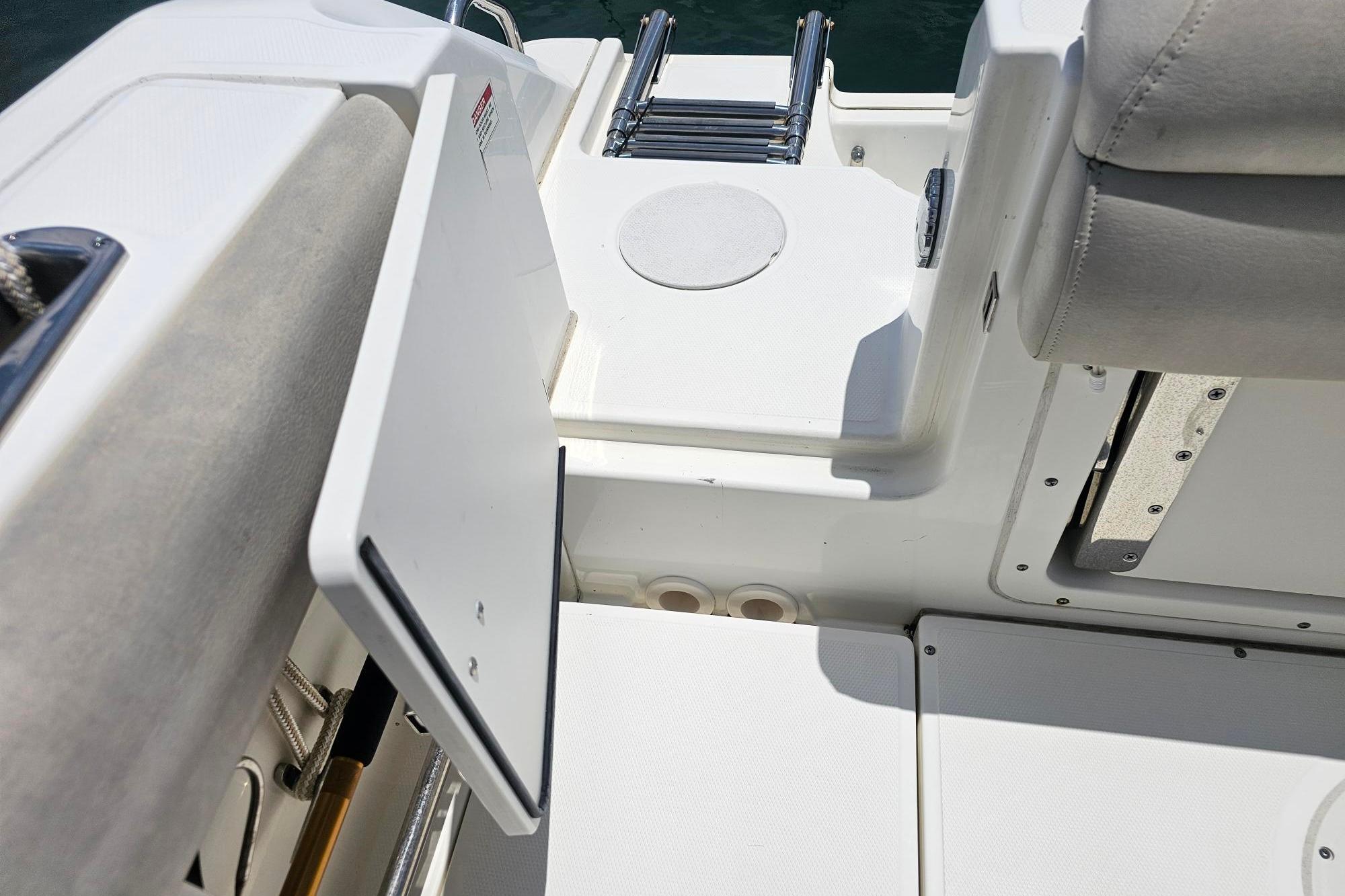 2017 Boston Whaler 230 Outrage boat interior with open storage compartment and seating.
