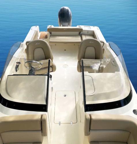 2025 Scout 215 Dorado boat interior with dual seating and steering wheel on calm water.