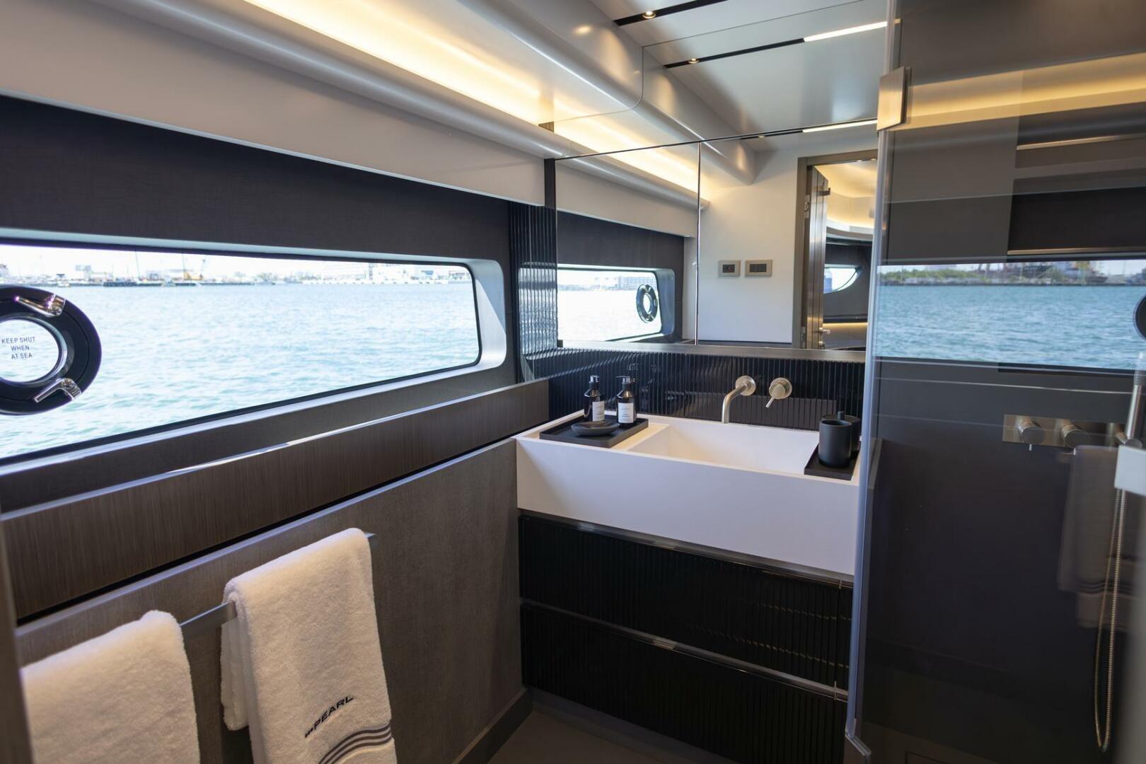 Luxurious bathroom interior on 2023 Pearl 72 yacht with ocean view and modern fixtures.