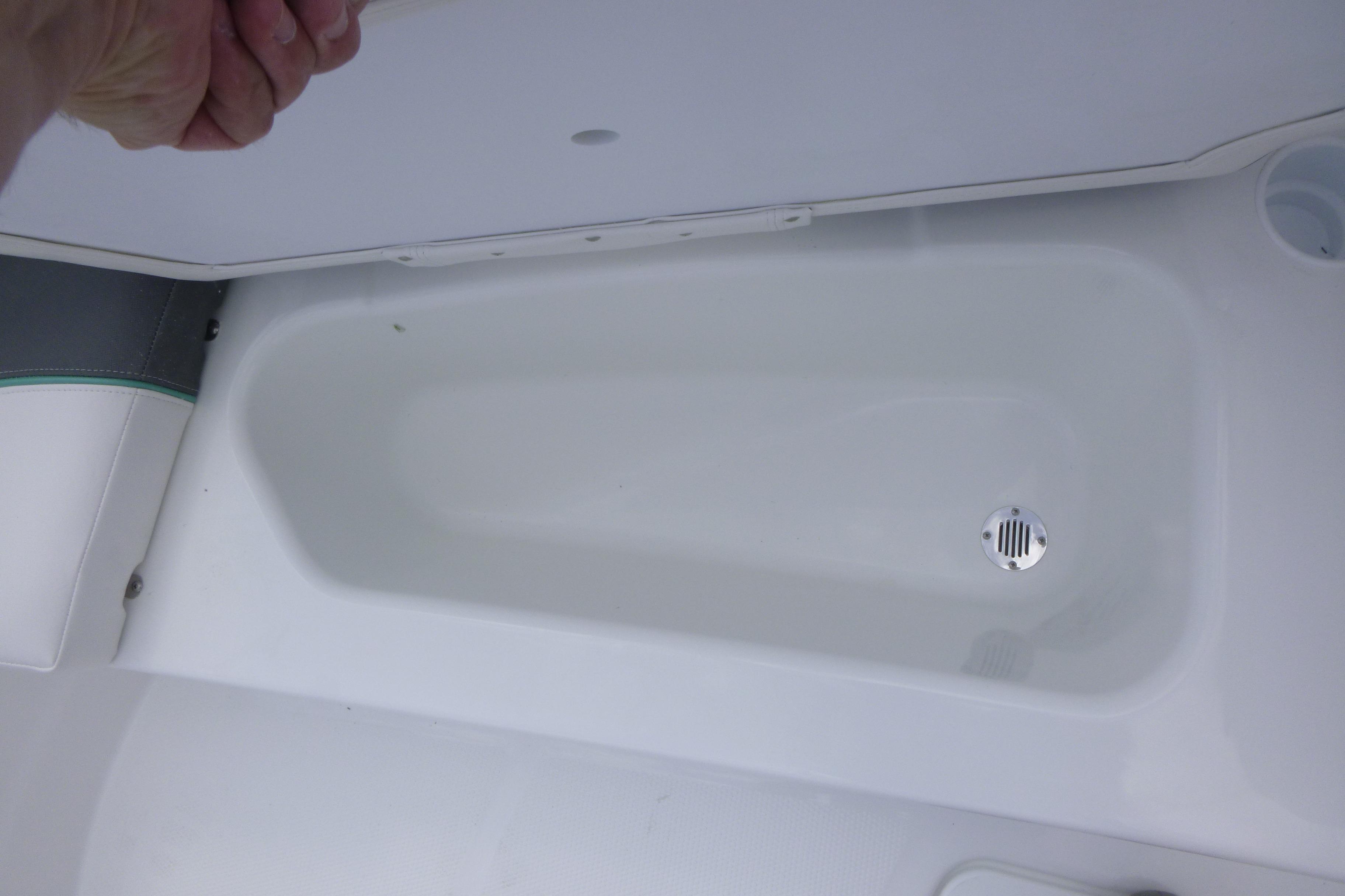 Storage compartment in 2026 Tahoe T16 boat with drain plug.