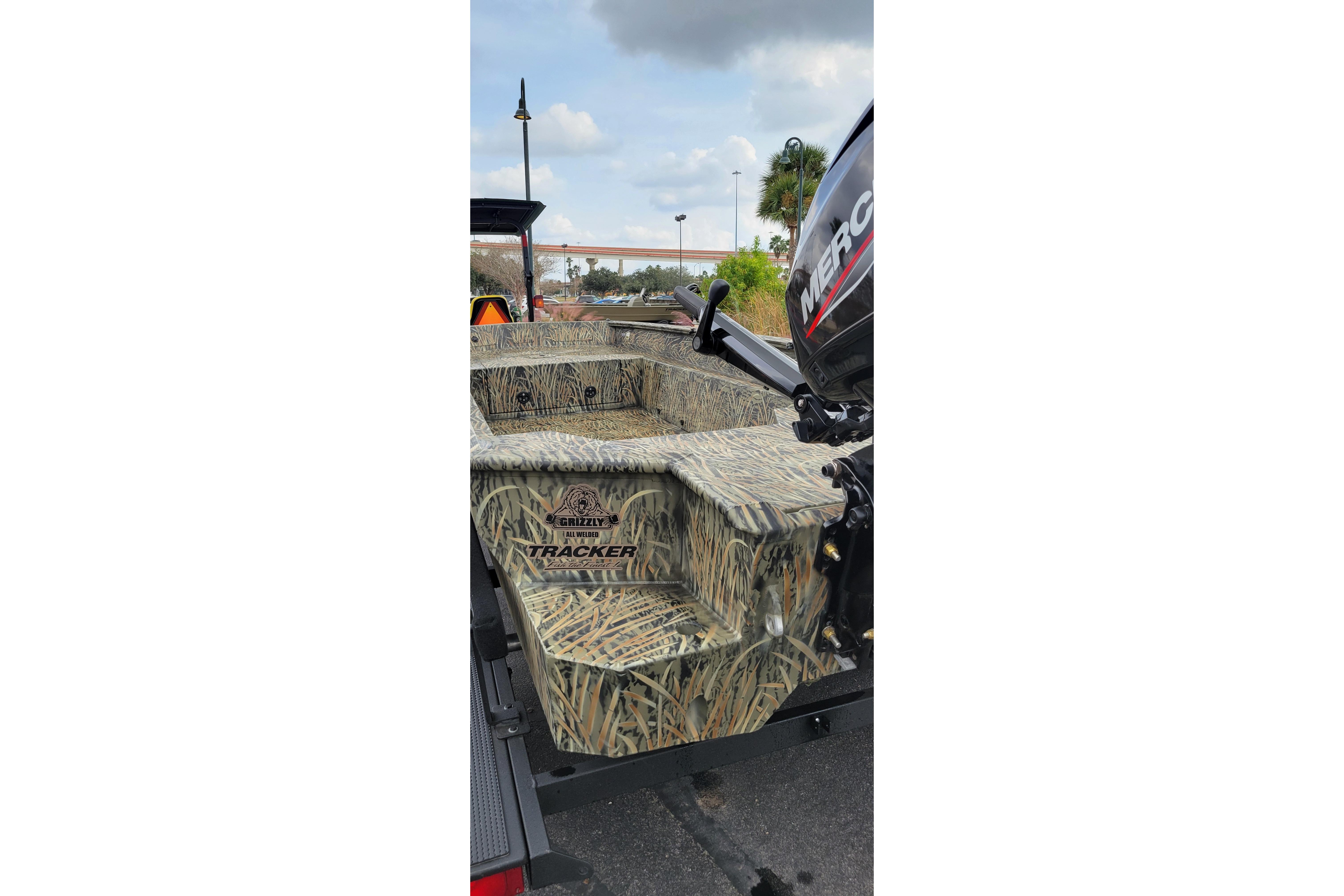 2025 Tracker Grizzly 1650 T Prairie Wings Edition boat with camouflage design and Mercury engine.