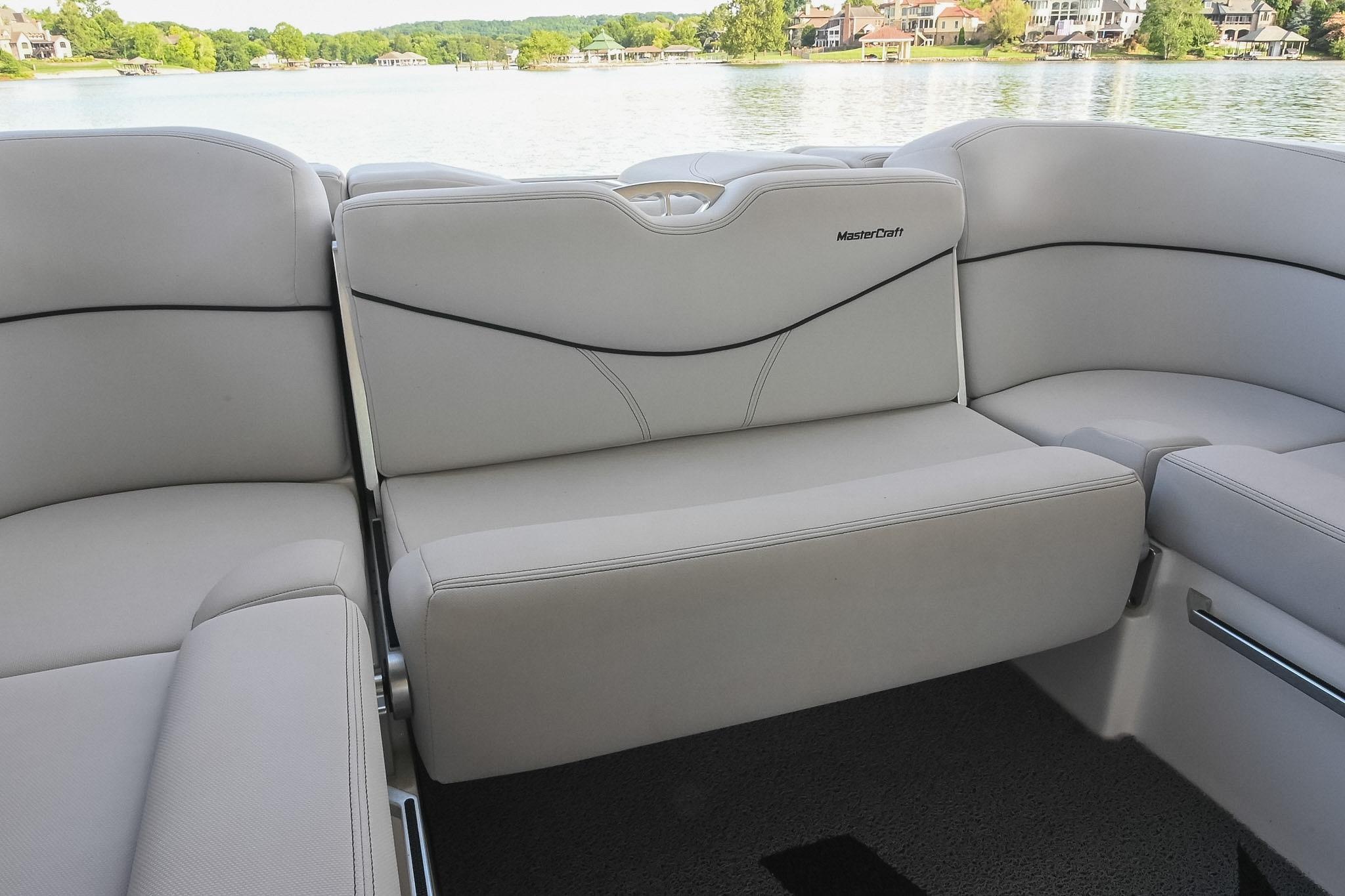 2018 MasterCraft X23 boat interior with luxurious seating and scenic lake view.