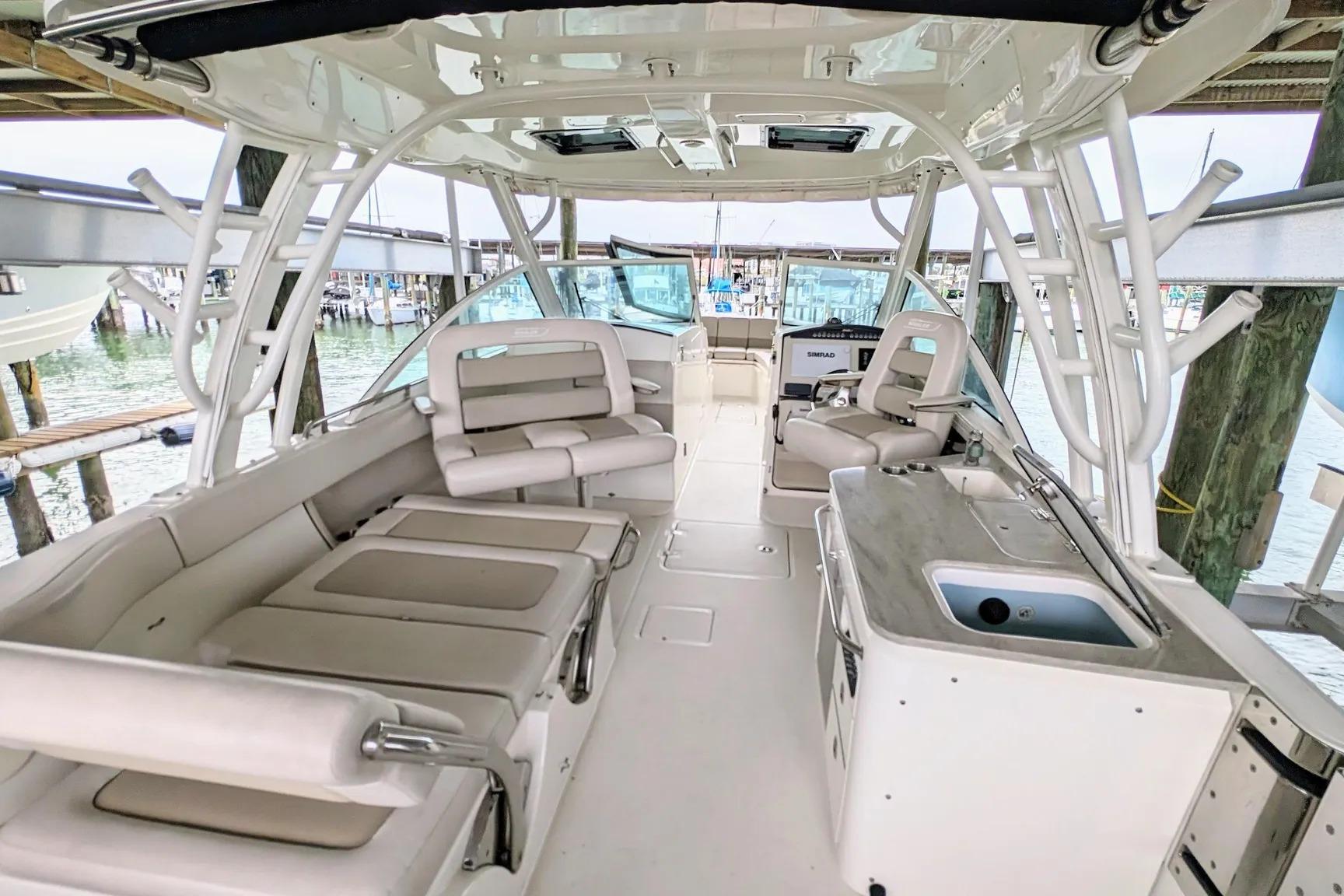 2017 Boston Whaler 320 Vantage boat interior with seating and helm, docked at marina.