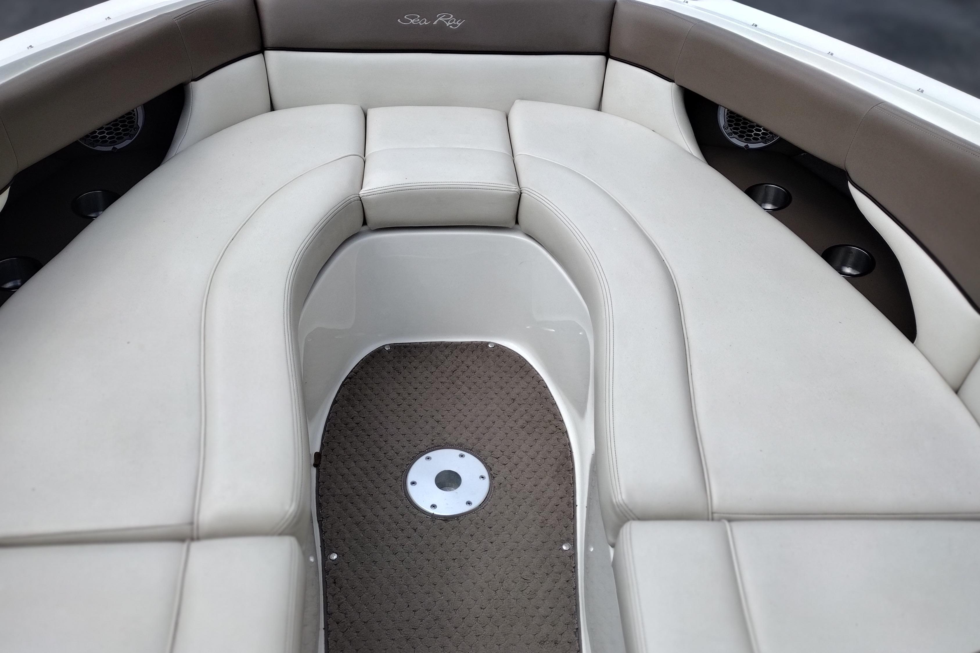 Interior seating of a 2013 Sea Ray 300 SLX boat, featuring beige upholstery.