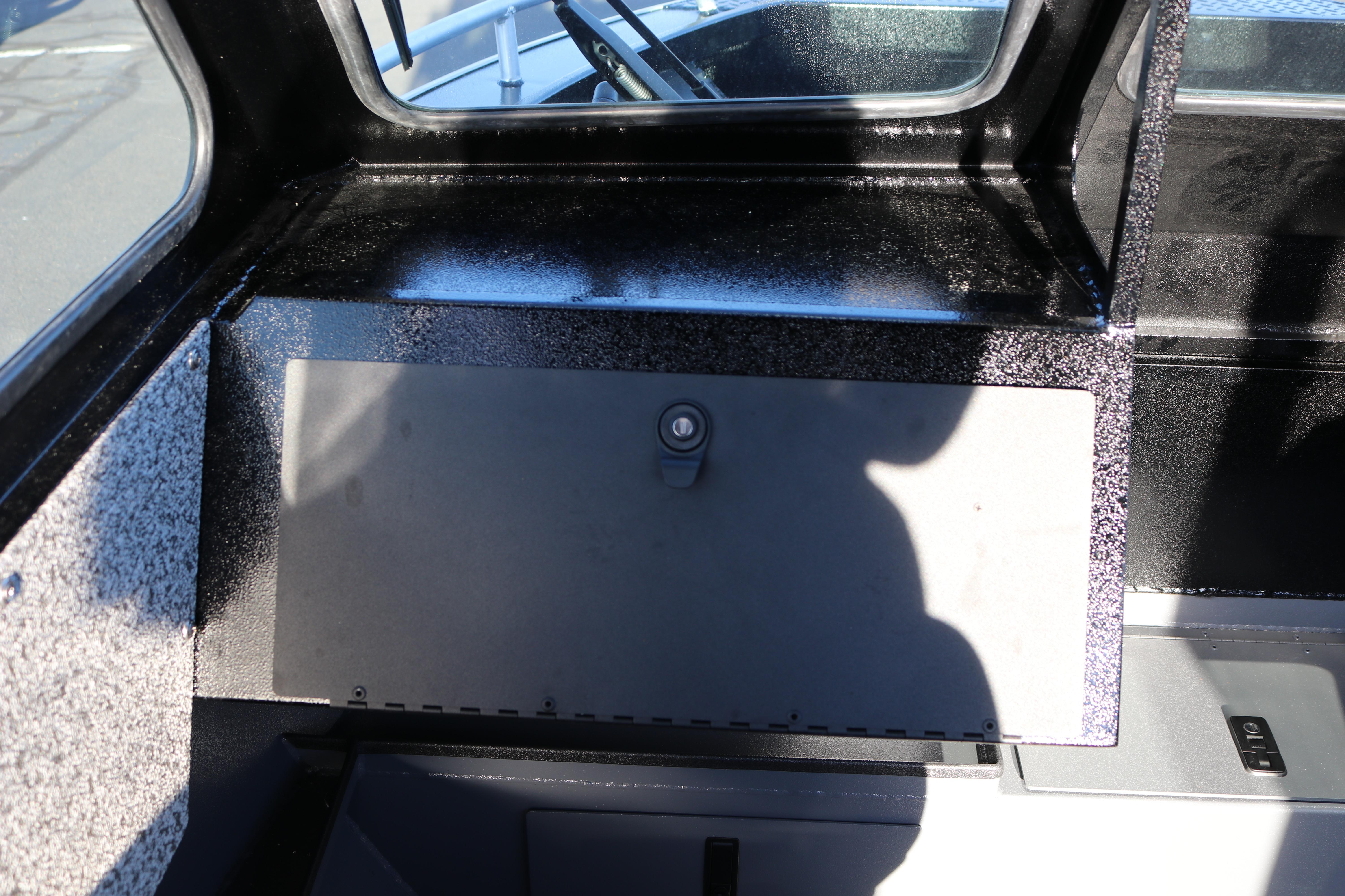 Interior view of 2026 Alumaweld Stryker X202 boat with storage compartment.
