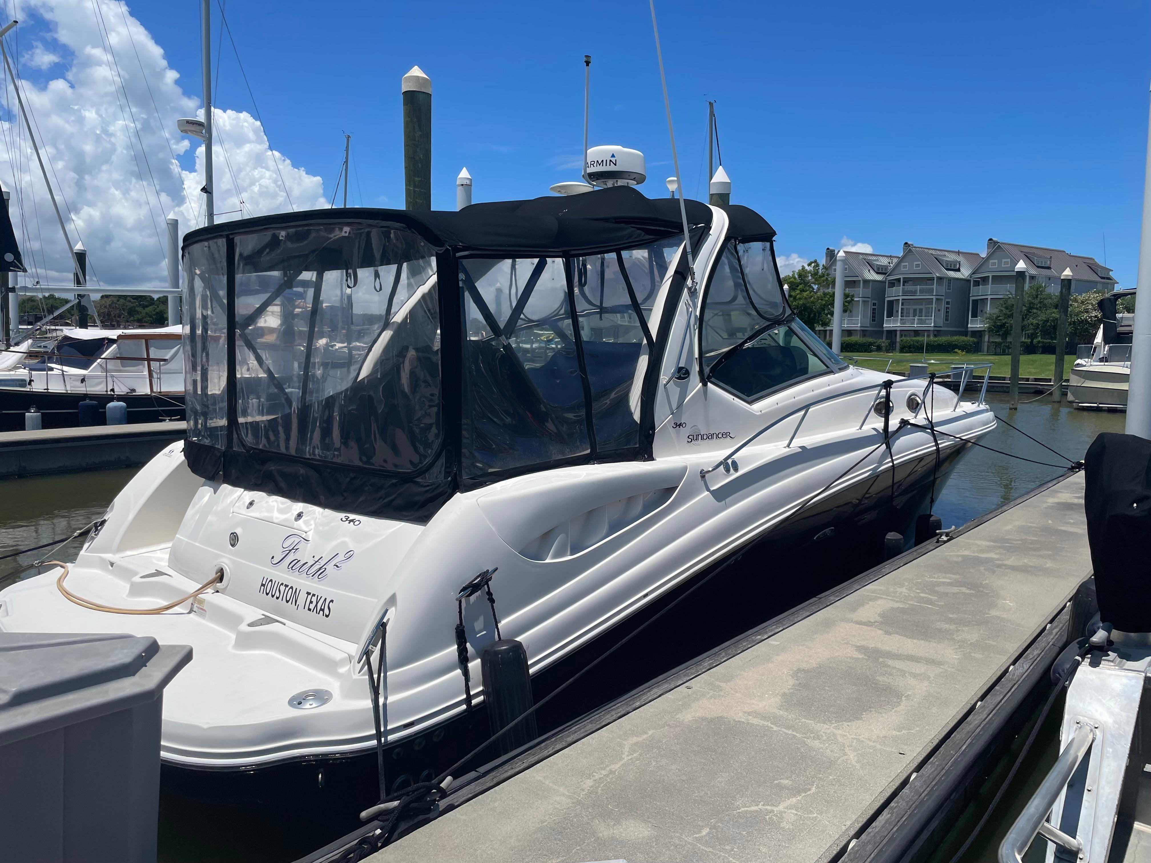 2007 Sea Ray 340 Sundancer docked at marina under clear blue sky.