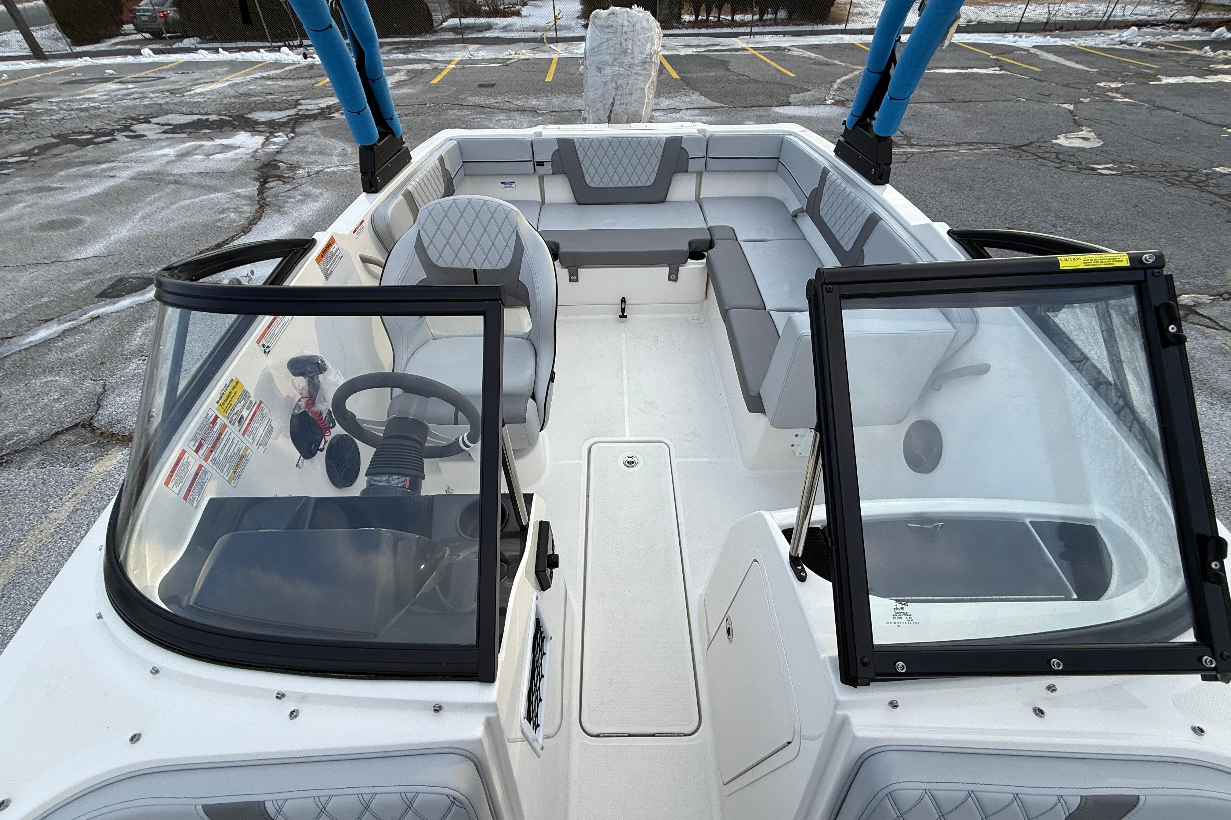 2026 Bayliner VR4 Bowrider OB interior with seating and steering wheel in a parking lot.