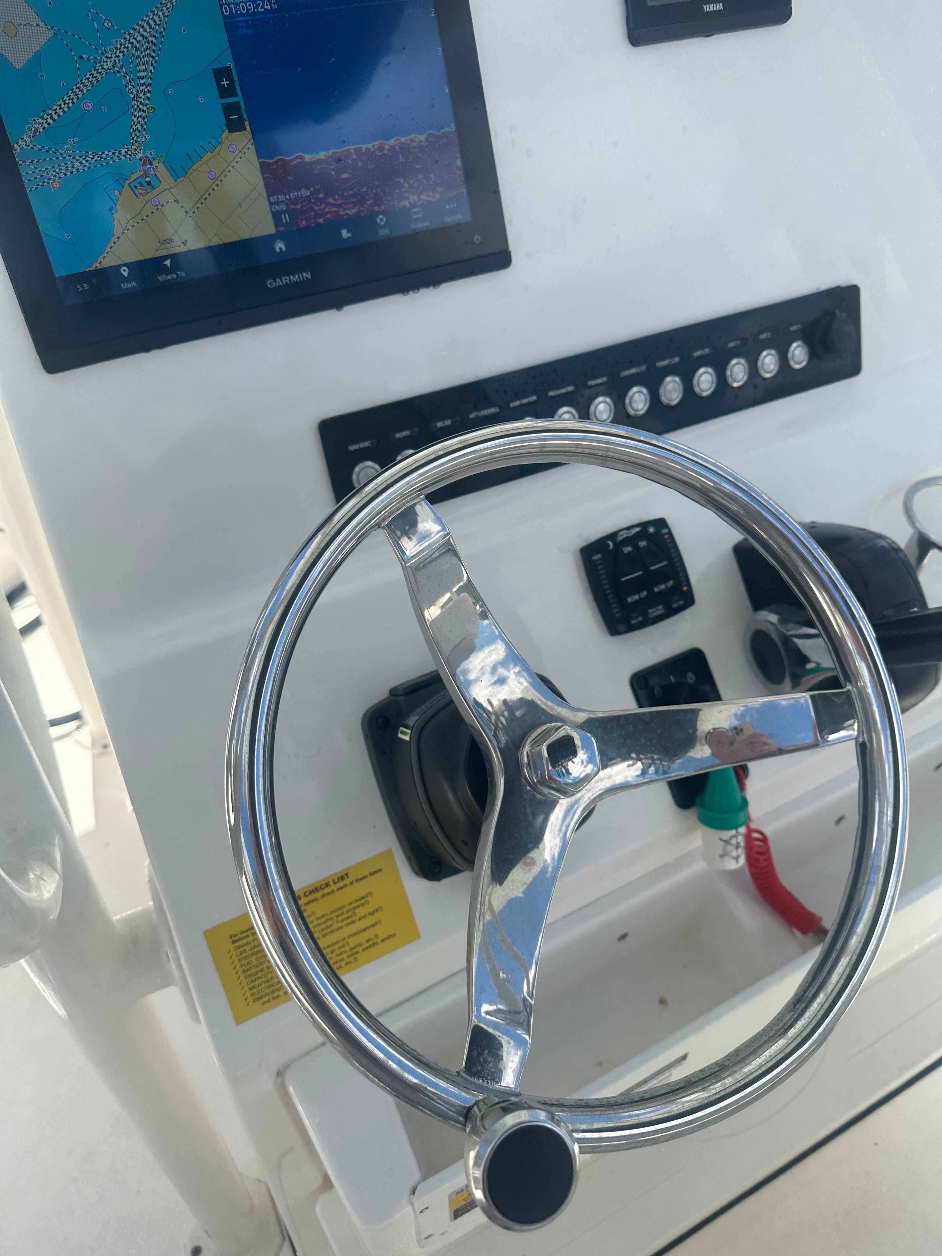 The image shows the helm of a Key West 219 FS boat with a navigation system.