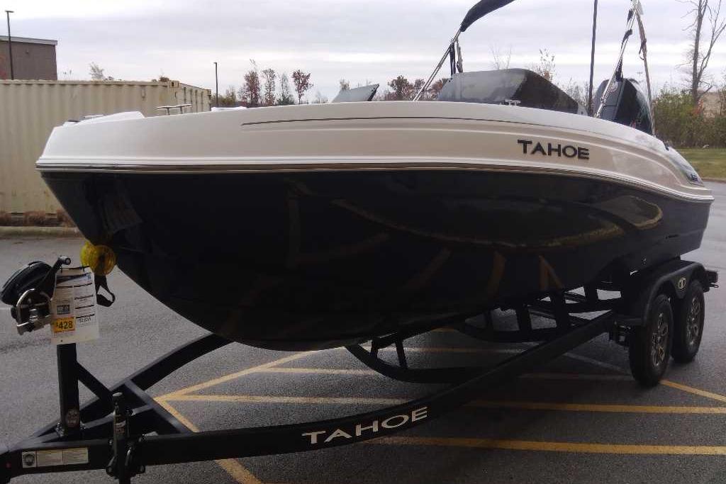 2026 Tahoe T21 boat on trailer, parked outdoors, showcasing sleek design.