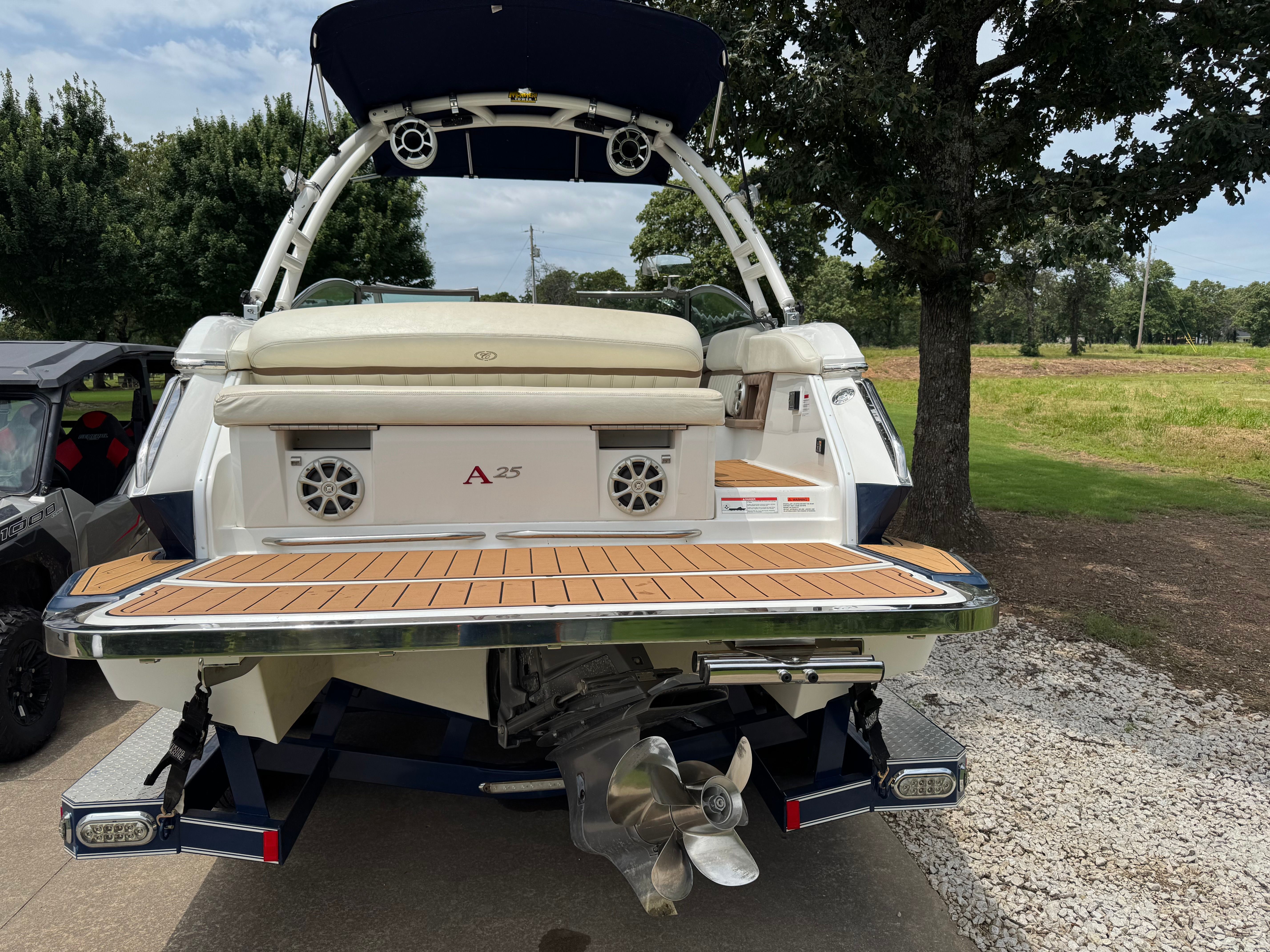 The image shows the rear of a 2011 Cobalt A25 boat with a large swim platform.
